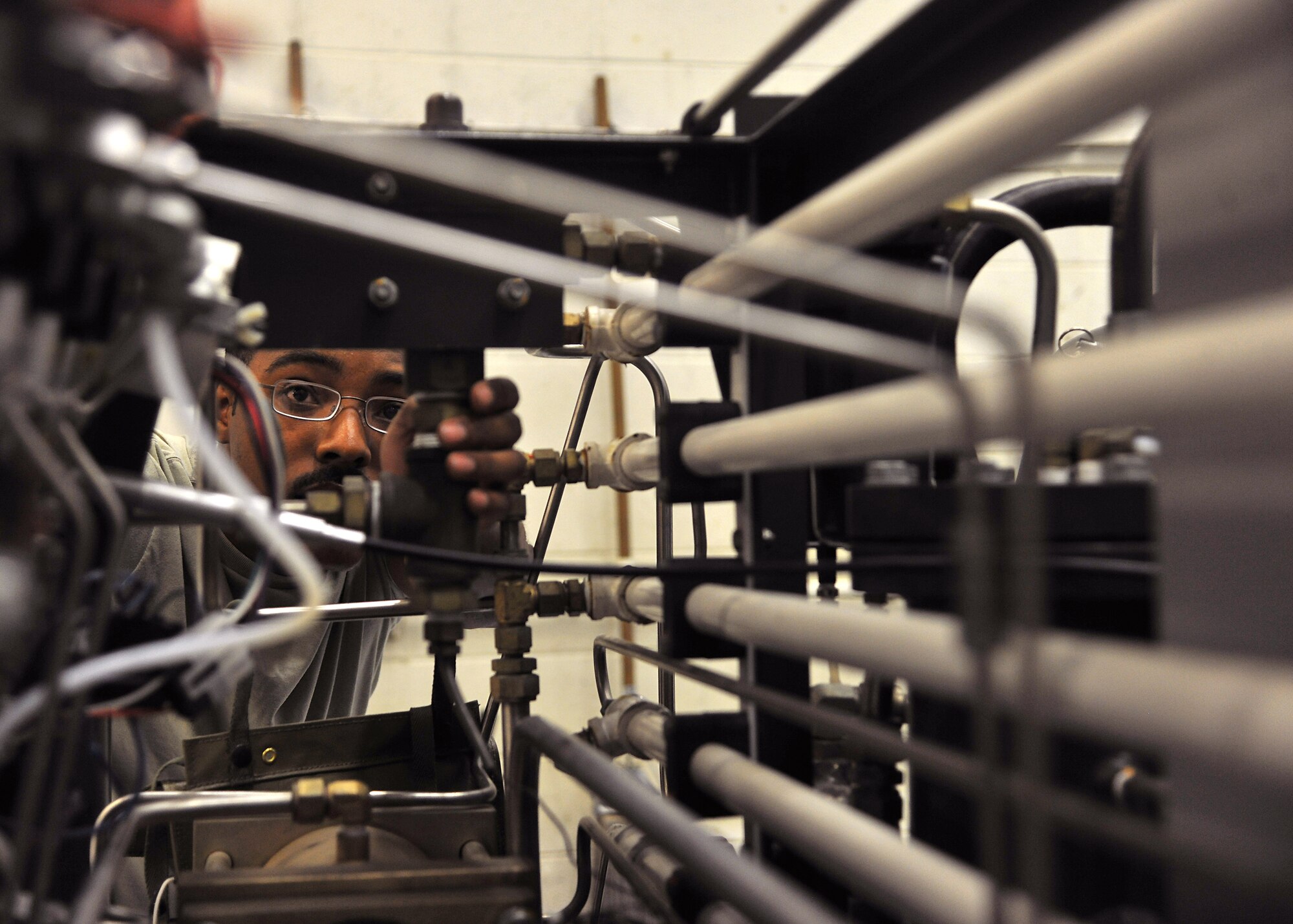 Airman 1st Class Arr’tez Cook, 69th Maintenance Squadron aerospace ground equipment apprentice, checks the self generating nitrogen serving cart for leaks on May 7, 2014, at Grand Forks Air Force Base, N.D. Cook performs phase two inspections daily by checking wire components, bolts, screws and washers on  equipment. (U.S. Air Force photo/Senior Airman Xavier Navarro)