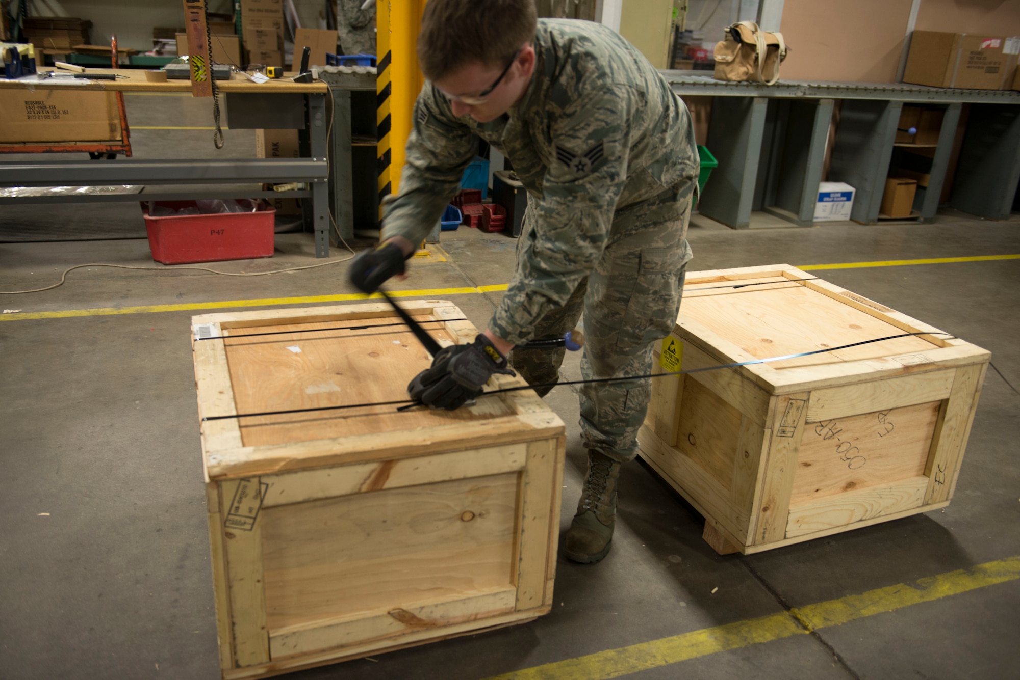 Senior Airman Garrett Medlock, cargo movement specialist from the 5th Logistics Readiness Squadron traffic management office, prepares crates for shipment at Minot Air Force Base, N.D., April 30, 2014. In addition to receiving and shipping Airmen’s household goods, TMO also assists with the shipment and packaging of mission essential parts and components. (U.S. Air Force photo/Airman 1st Class Sahara L. Fales)