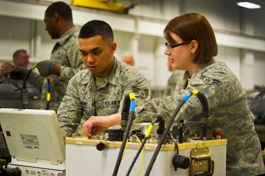 Airmen from the 5th Munitions Squadron assemble weapons during Tundra Thunder at Minot Air Force Base, N.D., May 12, 2014. The entire squadron, which is approximately 122 ammo personnel, participated in this event and built roughly 830 conventional munitions and 324 ALA-17 flare countermeasures. (U.S. Air Force photo/Senior Airman Brittany Y. Auld)