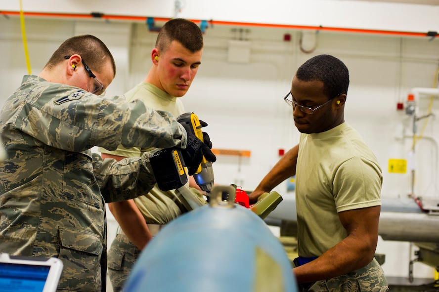 Airmen from the 5th Munitions Squadron assemble weapons during Tundra Thunder at Minot Air Force Base, N.D., May 12, 2014. The entire squadron, which is approximately 122 ammo personnel, participated in this event and built roughly 830 conventional munitions and 324 ALA-17 flare countermeasures. (U.S. Air Force photo/Senior Airman Brittany Y. Auld)