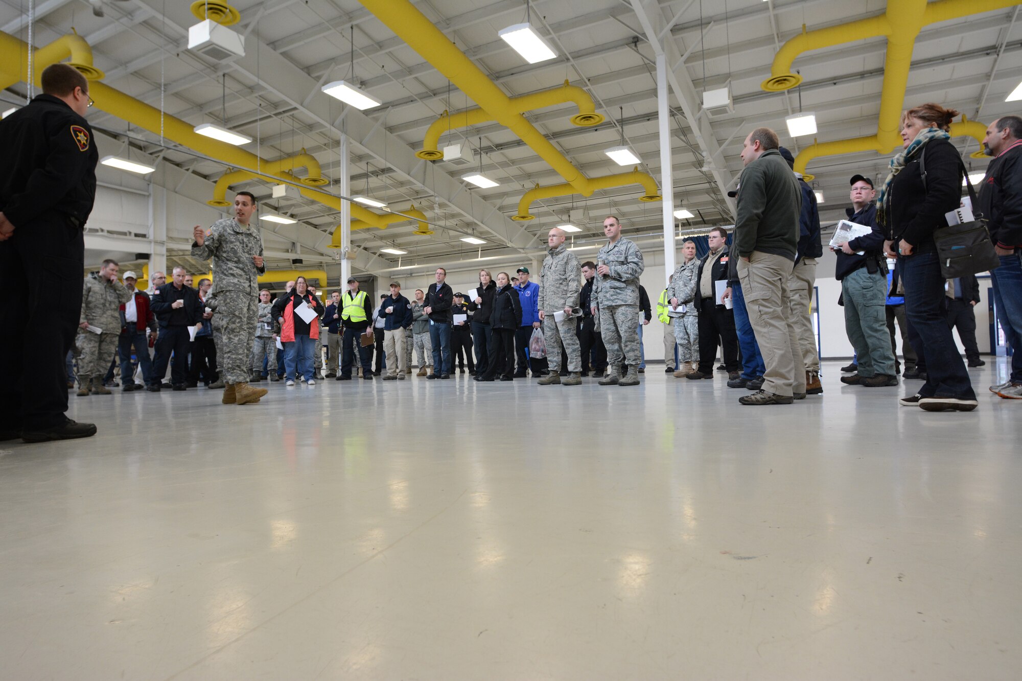 Participants of the 2014 State Interoperable Mobile Communications Exercise listen to their morning briefing at the Sunnyview Exposition Center in Oshkosh, Wis., May 15, 2014. More than 100 agencies from 34 communication platforms were in attendance. Members of the Wisconsin National Guard attended to test their ability to communicate with other agencies to ensure everything worked properly should an emergency situation arise. (Air National Guard photo by Senior Airman Andrea F. Liechti)