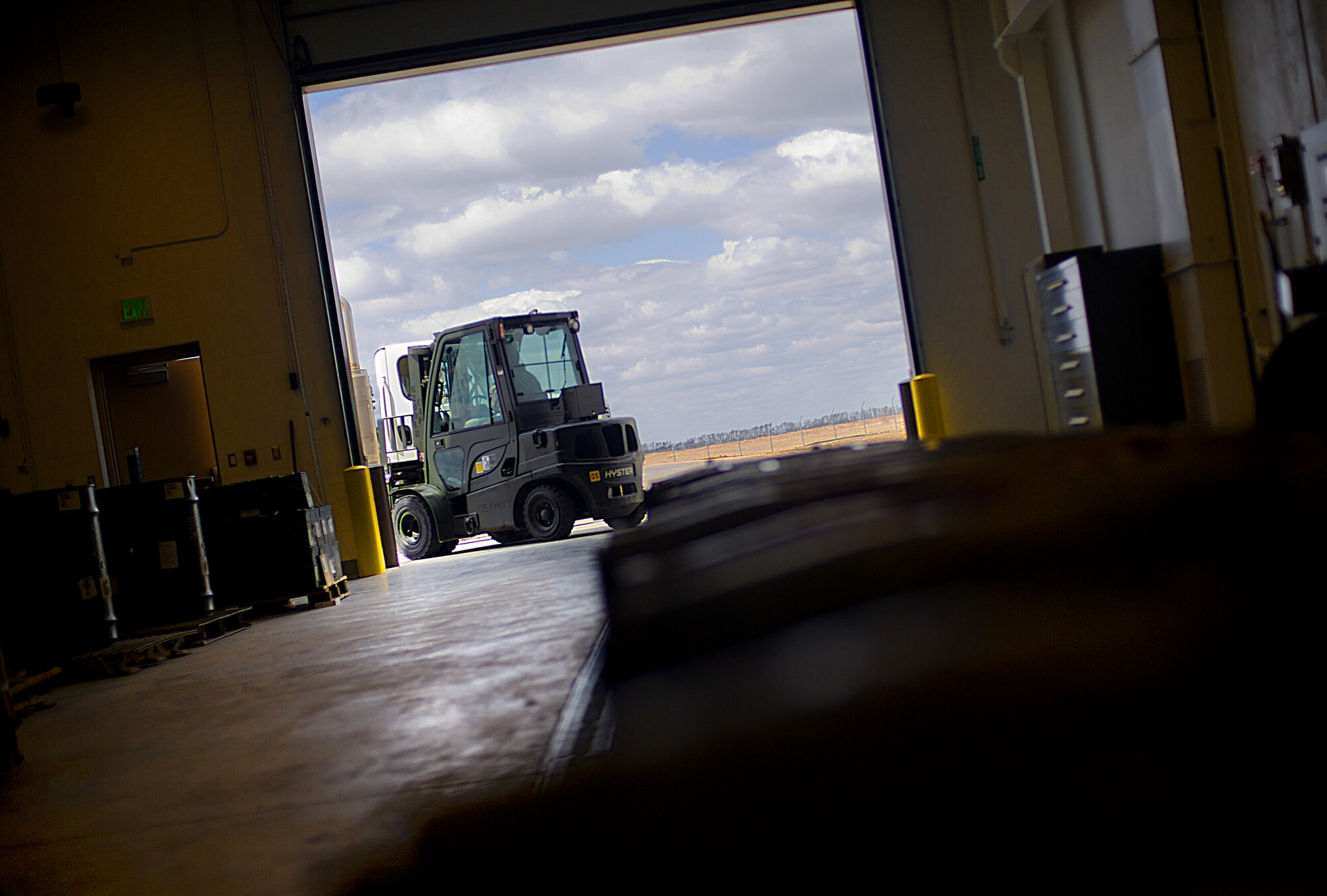 An Airman from the 5th Munitions Squadron unloads weapons during Tundra Thunder at Minot Air Force Base, N.D., May 12, 2014. The exercise is intended to flex the 5th MUN’s conventional munitions generation capabilities to support B-52H Stratofortress operations, either deployed or at home station.  (U.S. Air Force photo/Senior Airman Brittany Y. Auld)