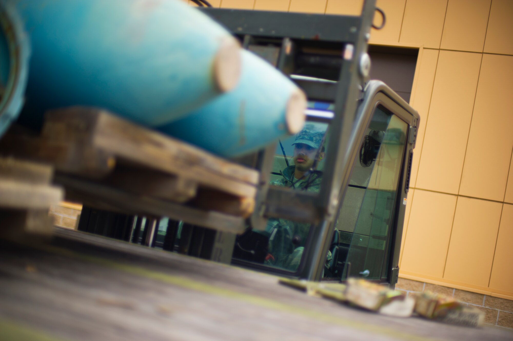 An Airman from the 5th Munitions Squadron unloads weapons during Tundra Thunder at Minot Air Force Base, N.D., May 12, 2014. The exercise is intended to flex the 5th MUN’s conventional munitions generation capabilities to support B-52H Stratofortress operations, either deployed or at home station.  (U.S. Air Force photo/Senior Airman Brittany Y. Auld)