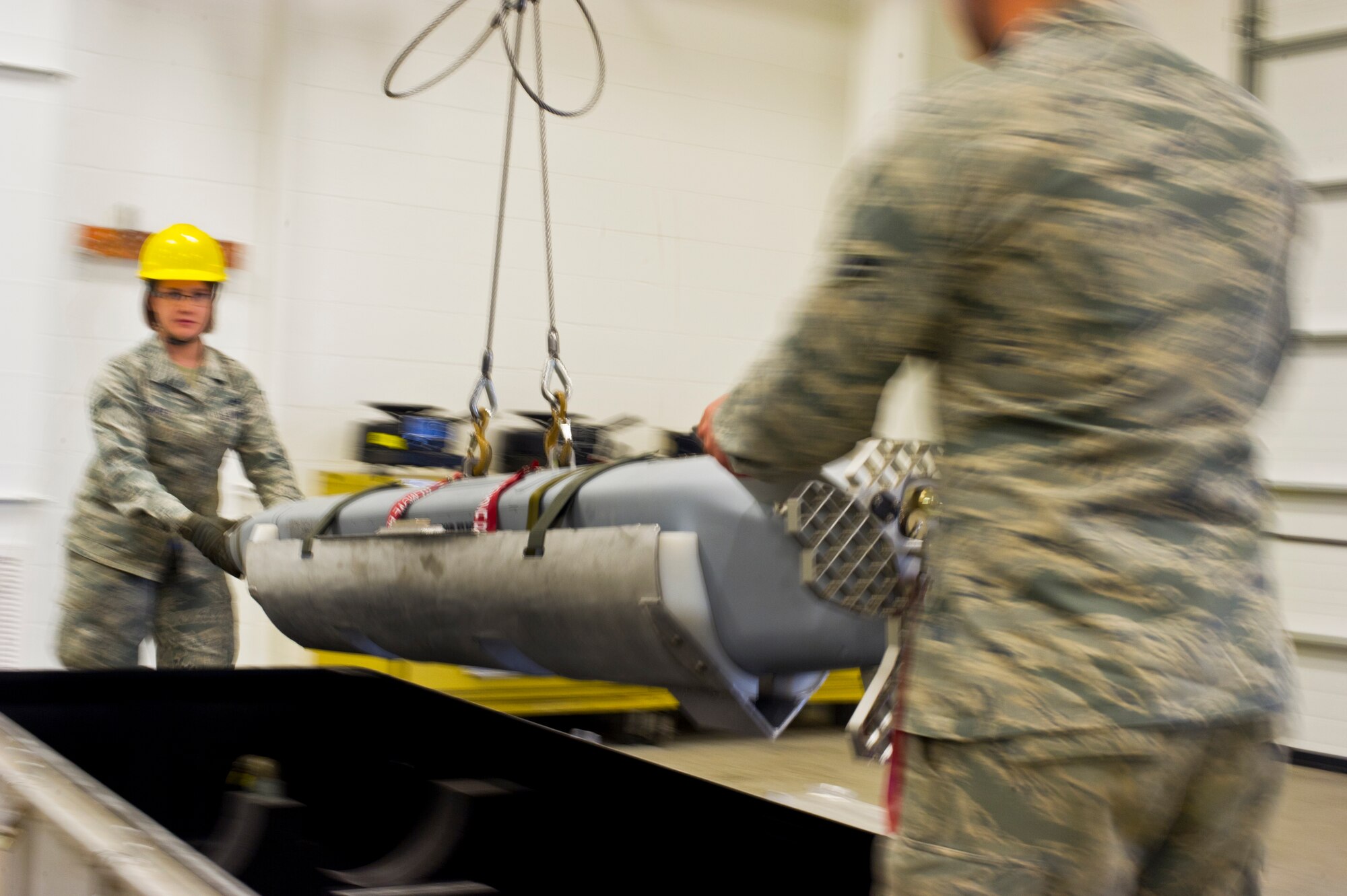 Airman 1st Class Alyssa Shuffler, 5th Munitions Squadron munitions journeyman, moves a weapon into a crate during Tundra Thunder at Minot Air Force Base, N.D., May 12, 2014. Tundra Thunder is a five-day internal 5th Munitions Squadron training exercise designed to evaluate and validate the 5th MUNS warfighting capabilities in support of conventional operations.  (U.S. Air Force photo/Senior Airman Brittany Y. Auld)
