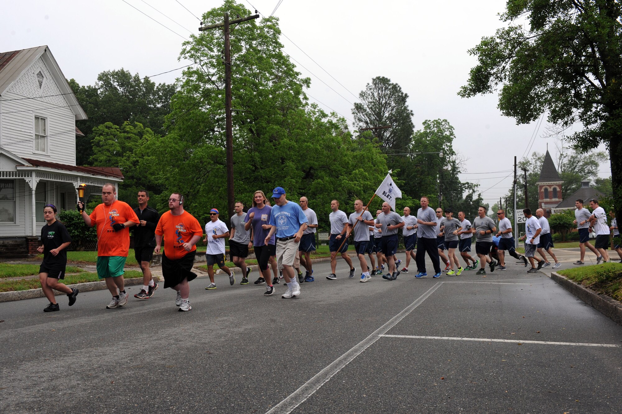 Members of the 4th Security Forces Squadron join the Goldsboro Police Department to participate in the North Carolina Law Enforcement Torch Run, May 14, 2014, in Mt. Olive, North Carolina. The run was held during National Police Week, which honors fallen police officers every year. (U.S. Air Force photo/Airman 1st Class Aaron J. Jenne)