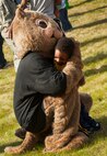 Darby the Dak-rat, 5th Force Support Squadron mascot, embraces a child at his retirement party at Minot Air Force Base, N.D., May 15, 2014. Darby has been a goodwill ambassador at Minot AFB for nearly 20 years. (U.S. Air Force photo/Airman 1st Class Apryl Hall)