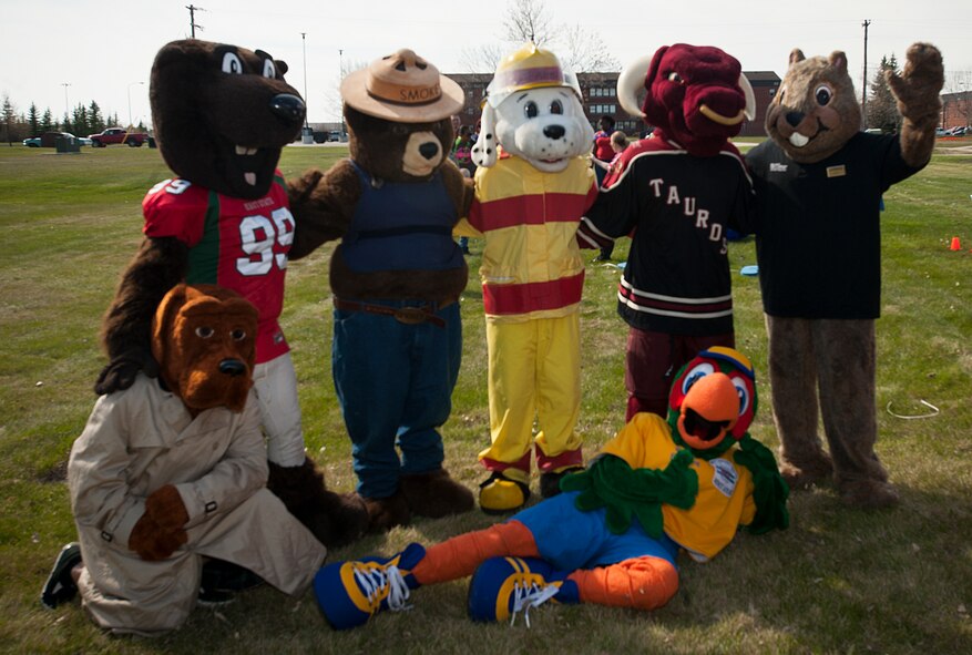 Darby the Dak-rat, 5th Force Support Squadron mascot, poses with some of his closest friends at his retirement party at Minot Air Force Base, N.D., May 15, 2014. After 20 years of service, Darby retired and handed over his mascot duties to Darcy the Dragon. (U.S. Air Force photo/Airman 1st Class Apryl Hall)