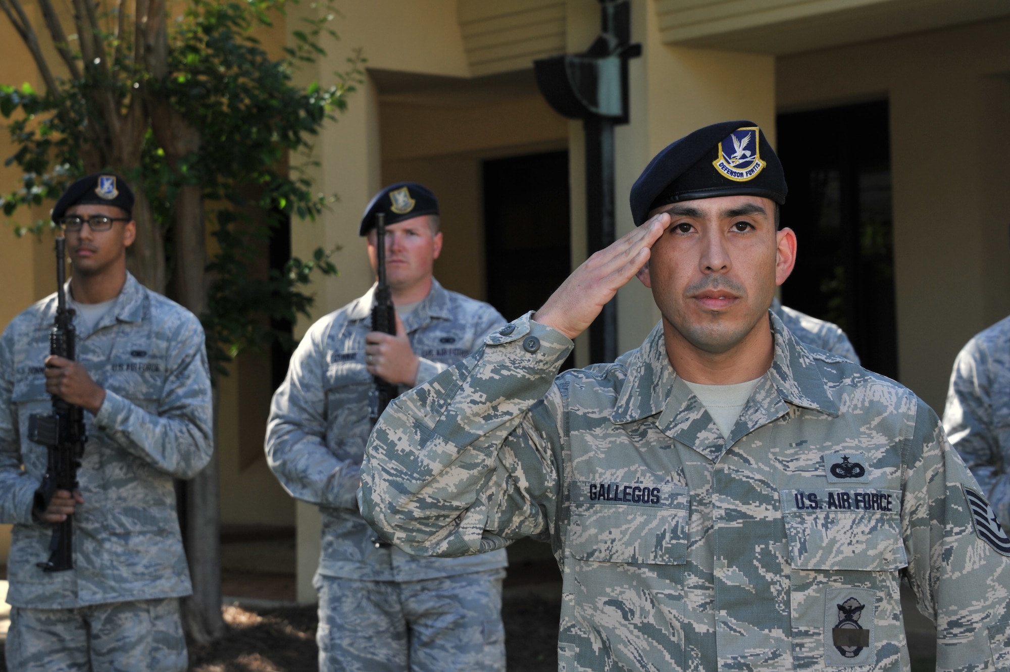 Tech. Sgt. Gilbert Gallegos, 42nd Security Forces Squadron, salutes the flag after leading a 21-gun salute during a National Police Week retreat ceremony here, May, 16, 2014. The 42nd SFS held a variety of events for the week to recognize the men and women in law enforcement who lost their lives in the line of duty. (U.S. Air Force photo by Staff Sgt. Natasha Stannard)
