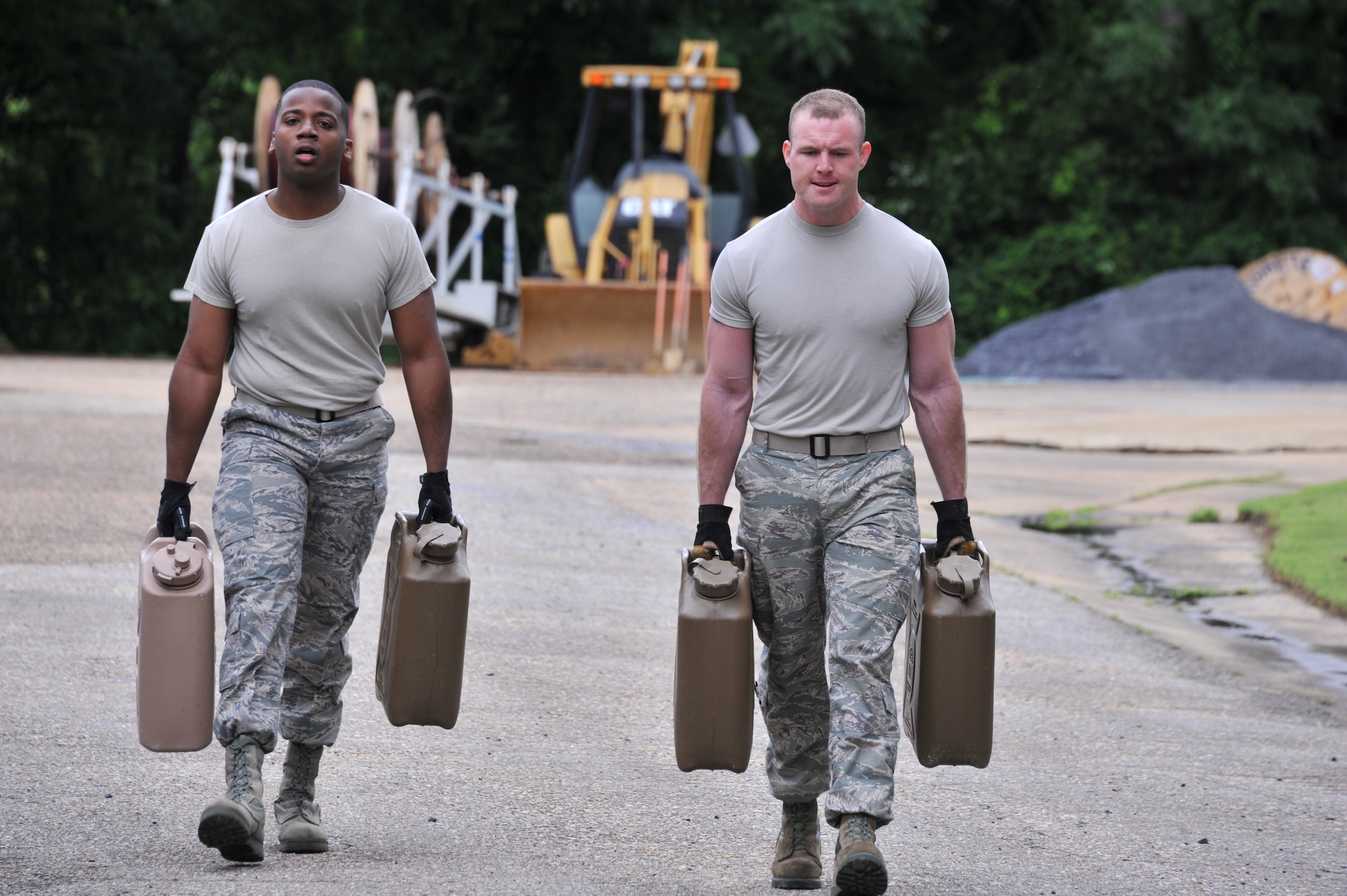 Senior Airman Jeffrey Brown, 42nd Civil Engineer Squadron firefighter, and Airman 1st Class Kyle Costello, 42nd Civil Engineer Squadron firefighter, carry fuel cans as part of the National Police Week obstacle course challenge organized by the 42nd Security Forces Squadron, on Maxwell Air Force Base, May 15, 2014.  The obstacle course pitted teams of two from various units on base against each other in a race for best time. (U.S. Air Force Photo by Staff Sgt. Gregory Brook)