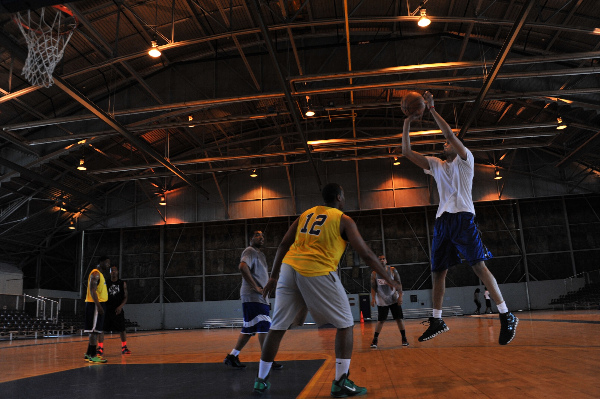 Marcus Donnel, SFS 2 team member, shoots a jump-shot over Jimmy Nickson, SFS 1 team member, during the the 42nd Security Forces Squadron's National Police Week three-on-three basketball tournament at Maxwell Air Force Base, May 13, 2014. The SFS 1 team won the first round against SFS 2. (U.S. Air Force photo by Staff Sgt. Natasha Stannard)
