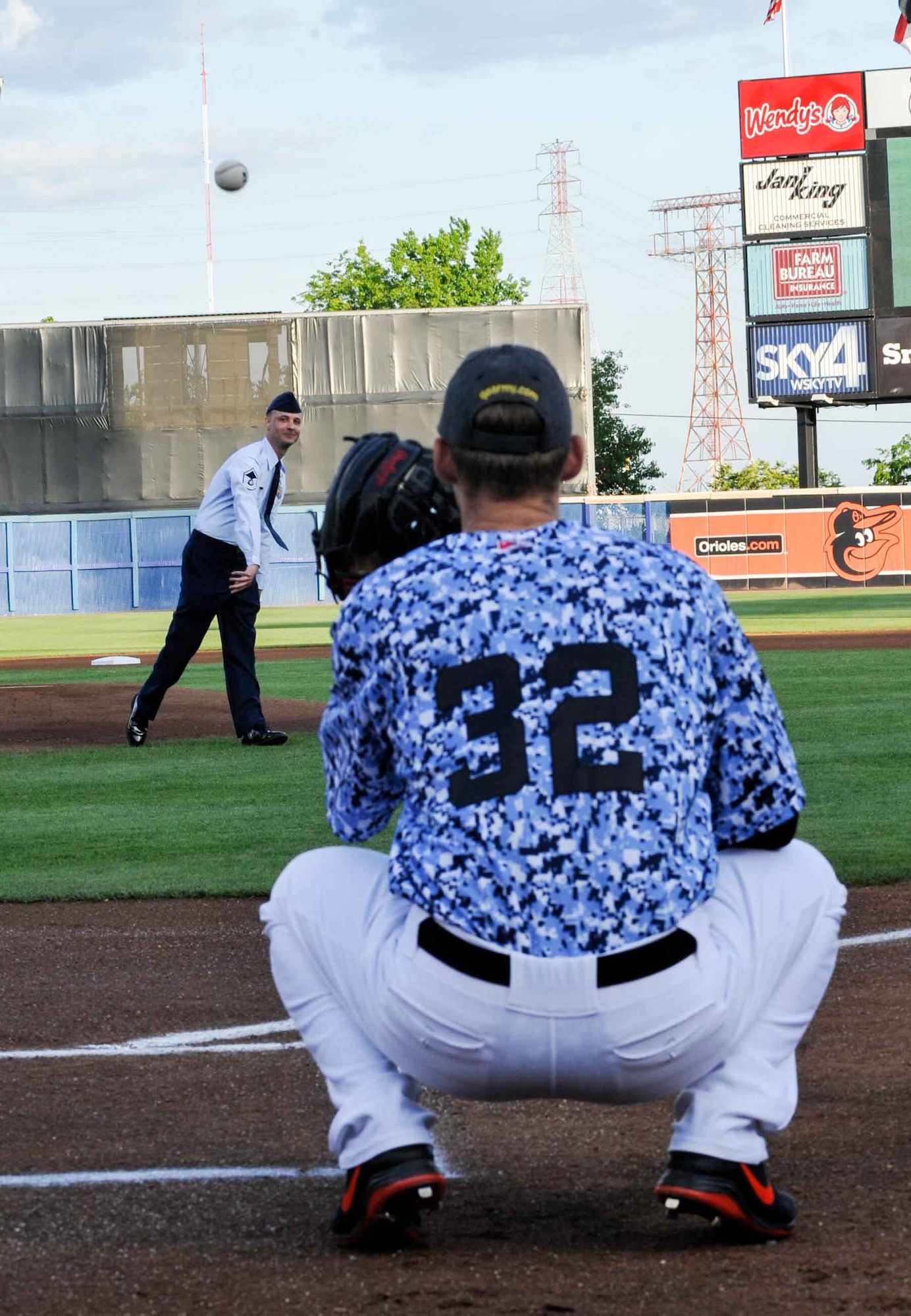 U.S. Air Force Master Sgt. Tyler Allan, 1st Maintenance Squadron low observable section chief,  throws out the first pitch at the Norfolk Tides’ 19th Annual Armed Forces Night at Harbor Park Stadium in Norfolk Va., May 17, 2014. The Tides wore digital camouflage print uniforms during the game against the Pawtucket Red Sox to honor Service members from all branches of the Armed Forces. (U.S. Air Force photo by Staff Sgt. Wesley Farnsworth/Released)