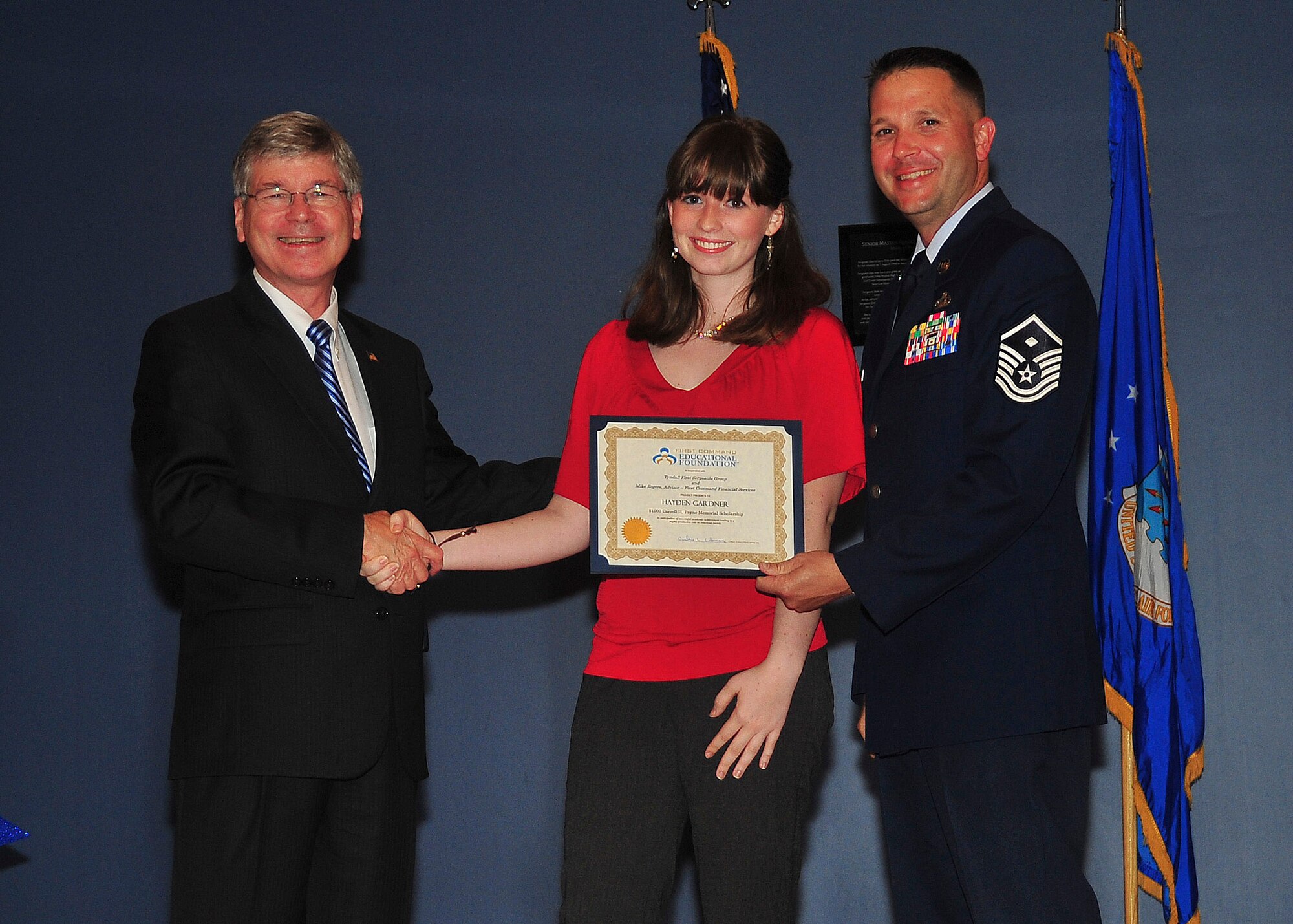 Hayden Gardner, daughter of Chief Master Sgt. Jerry Gardner, 601st Air and Space Operations Center Combat Operations Division drill status guardsman superintendent, receives a $1,000 First Command Educational Foundation Scholarship from the Tyndall First Sergeants group May 13 at the Horizons Community Center. She was presented this award to recognize the unique challenges children face when growing up with a military parent(s). (U.S. Air Force photo by Airman 1st Class Dustin Mullen