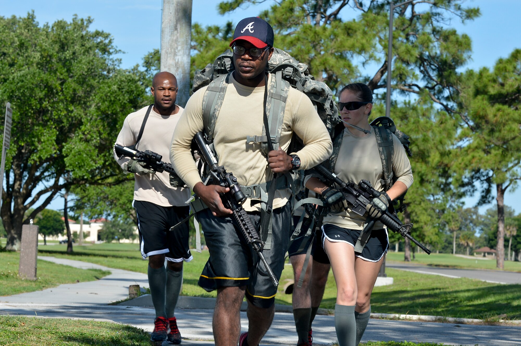 Members from the 6th Security Forces Squadron complete a ruck march as part of a defenders challenge, May 16, 2014 at MacDill Air Force Base, Fla. The challenge included a kayak race, ammo can lift, disassemble and reassemble a rifle, ruck march and an active shooter event.(U. S. Air Force photo by Senior Airman Jenay Randolph/Released)  
