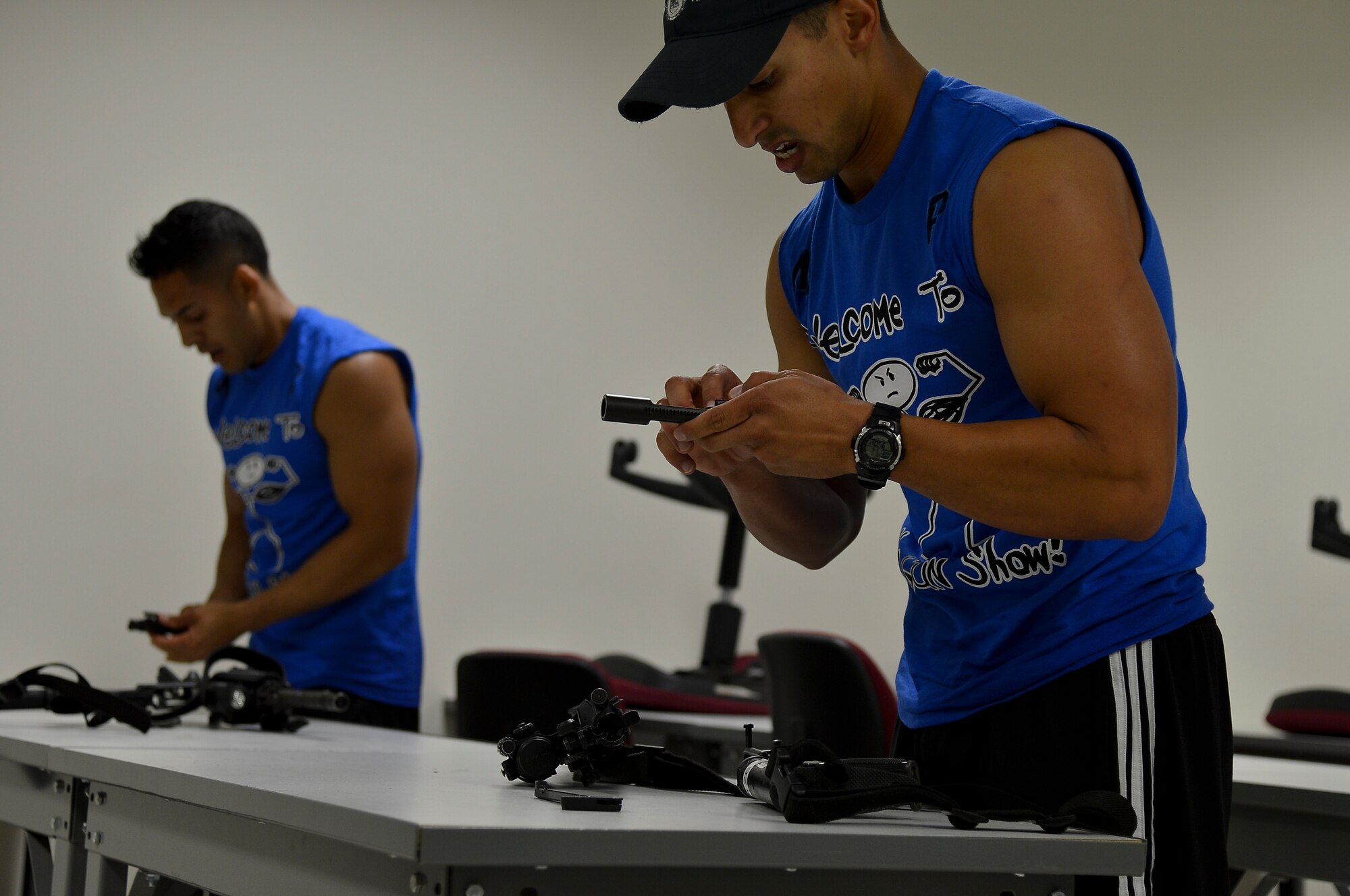 Members from the 6th Security Forces Squadron disassemble and reassemble an M-4 rifle during a defenders challenge, May 16, 2014 at MacDill Air Force Base, Fla. The challenge was one of many events held in celebration of National Police Week.(U. S. Air Force photo by Senior Airman Jenay Randolph/Released)  