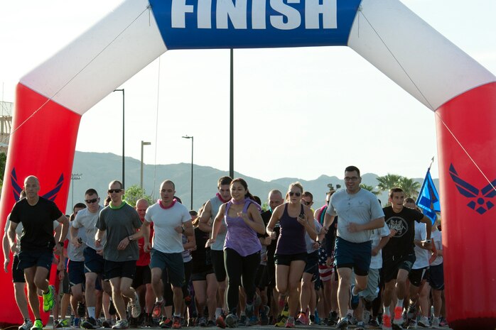 Participants take off at the start of the Remembrance 5 Kilometer run and one mile walk on May 16, 2014, at Nellis Air Force Base, Nev.   The run was the last one hosted by the 99th Force Support Squadron until the end of summer. (U.S. Air Force photo by Senior Airman Timothy Young)