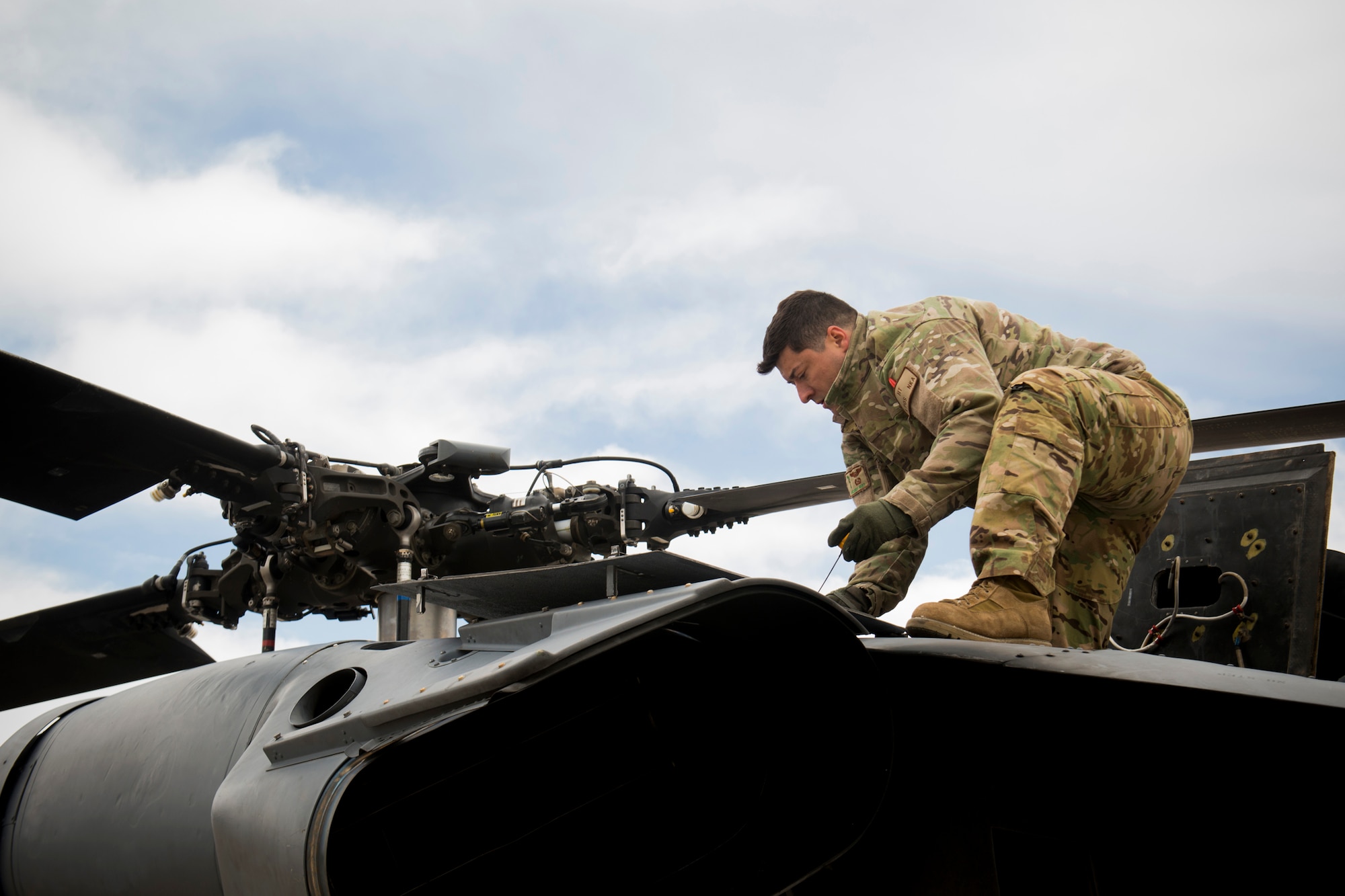 U.S. Air Force Tech. Sgt. Vincent Hnat, 41st Rescue Squadron special missions aviator out of Moody Air Force Base, Ga., inspects an HH-60G Pave Hawk May 6, 2014, during the Angel Thunder exercise at Flagstaff Pulliam Airport, Ariz. Hnat has participated in four consecutive Angel Thunder exercises and says he loves the opportunity the training presents to reconnect with friends from previous deployments and duty stations. (U.S. Air Force photo by Staff Sgt. Jamal D. Sutter/Released)