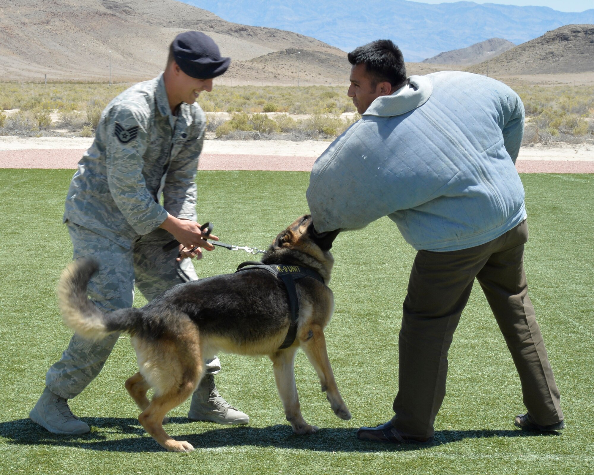 Alejandro, right, a Creech Air Force Base member, participates in a military working dog demonstration during National Police Week May 13, 2014. Police Week is a nation-wide event proclaimed by the president of the United States during the week of May 15 each year to recognize all law enforcement officers who have paid the ultimate sacrifice (Last names have been withheld for security reasons).(U.S. Air Force photo by Staff Sgt. A.K./Released)