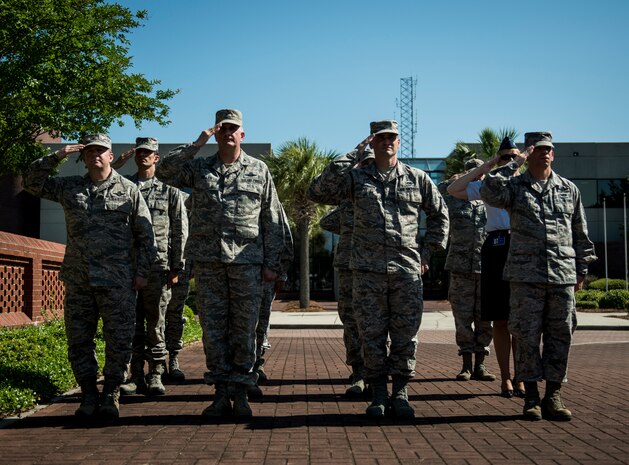 Joint Base Charleston leadership salute the flag during the Police Week Retreat ceremony May 16, 2014, at Joint Base Charleston – Air Base, S.C. The 628th SFS held different events and activities to commemorate National Police Week from May 11 to 17. (U.S. Air Force photo/ Senior Airman Dennis Sloan)