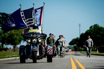 Members of the 628th Security Forces Squadron march towards the flagpole for a retreat ceremony May 16, 2014, on Joint Base Charleston, S.C. The 628th SFS was accompanied by members of the Patriot Guard Riders, a non-profit organization which ensures dignity and respect at memorial services honoring fallen military heroes, first responders and honorably discharged veterans. (U.S. Air Force photo/ Senior Airman Dennis Sloan)