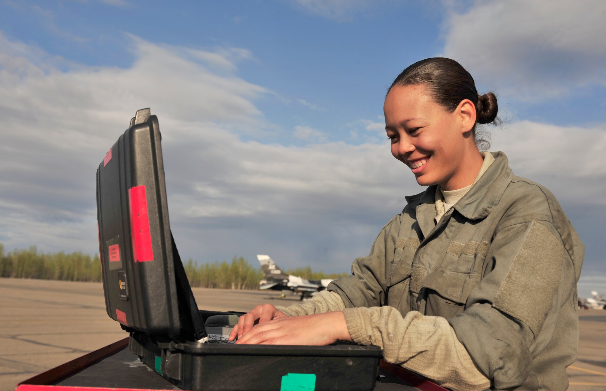 U.S. Air Force Airman 1st Class Desirae Perkins, 354th Aircraft Maintenance Squadron crew chief, checks a technical order May 16, 2014, Eielson Air Force Base, Alaska. The technical order displays step-by-step procedures for troubleshooting an F-16 Fighting Falcon. (U.S. Air Force photo by Senior Airman Ashley Nicole Taylor/Released)