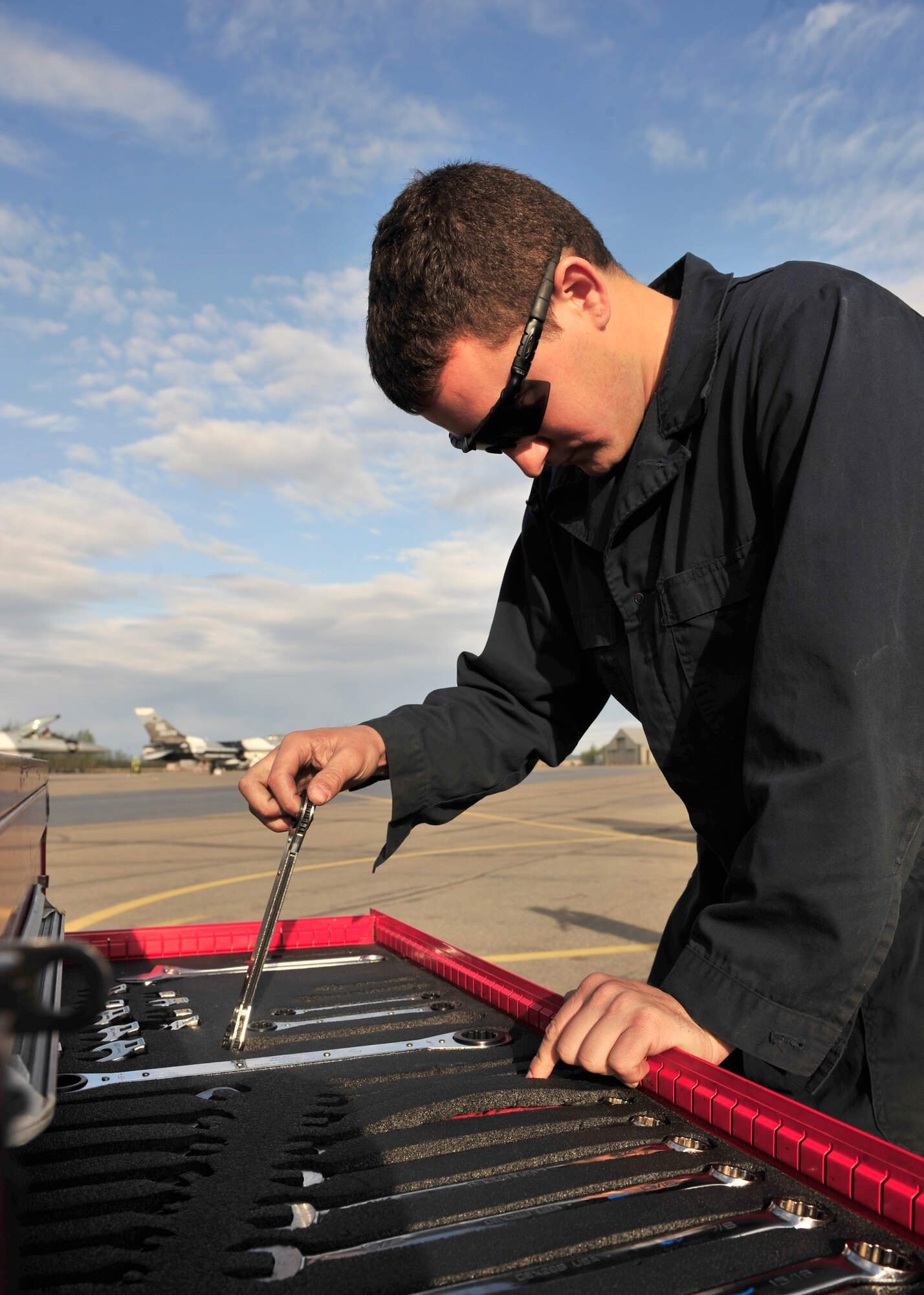 U.S. Air Force Senior Airman Adam Bowen, 354th Aircraft Maintenance Squadron crew chief, checks his toolbox during an F-16 Fighting Falcon inspection May 16, 2014, Eielson Air Force Base, Alaska. As a crew chief, Bowen ensures the aircraft is safe for flight. (U.S. Air Force photo by Senior Airman Ashley Nicole Taylor/Released)