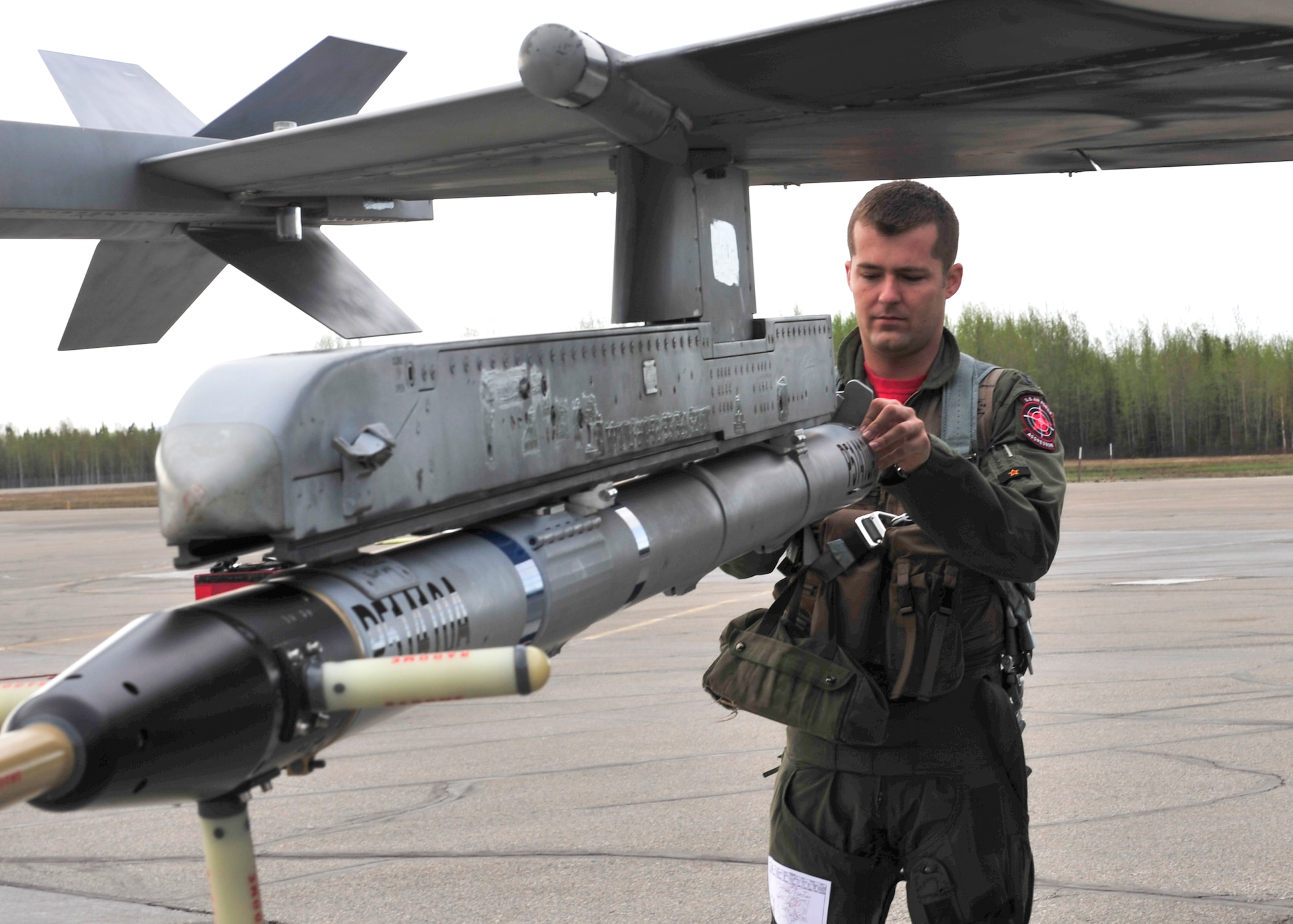 U.S. Air Force Capt. A.J. Roper, 18th Aggressor Squadron F-16 pilot, performs a walk-round inspection of an F-16 Fighting Falcon, May 16, 2014, Eielson Air Force Base, Alaska. Roper is flying in RED FLAG-Alaska 14-1, a two week-long air combat exercise. (U.S. Air Force photo by Senior Airman Ashley Nicole Taylor/Released)