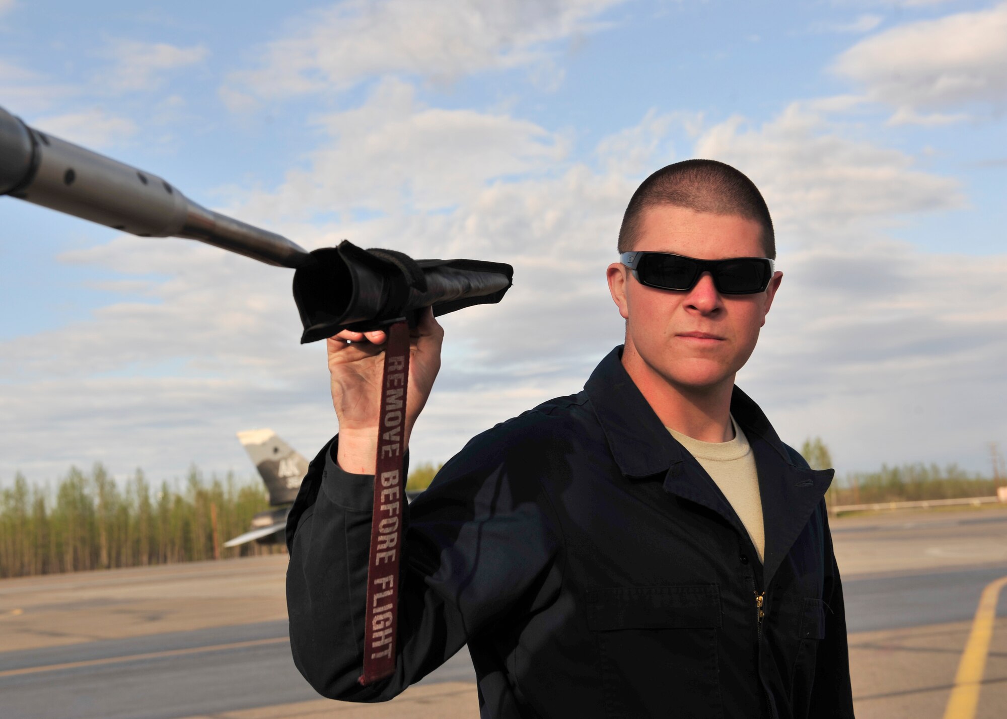 U.S. Air Force Airman 1st Class Kyle Lanning, 354th Aircraft Maintenance Squadron crew chief, removes covers from an F-16 Fighting Falcon May 16, 2014, Eielson Air Force Base, Alaska. After all the covers are removed, Lanning prepares the jet for the pilot’s pre-flight inspection. (U.S. Air Force photo by Senior Airman Ashley Nicole Taylor/Released)