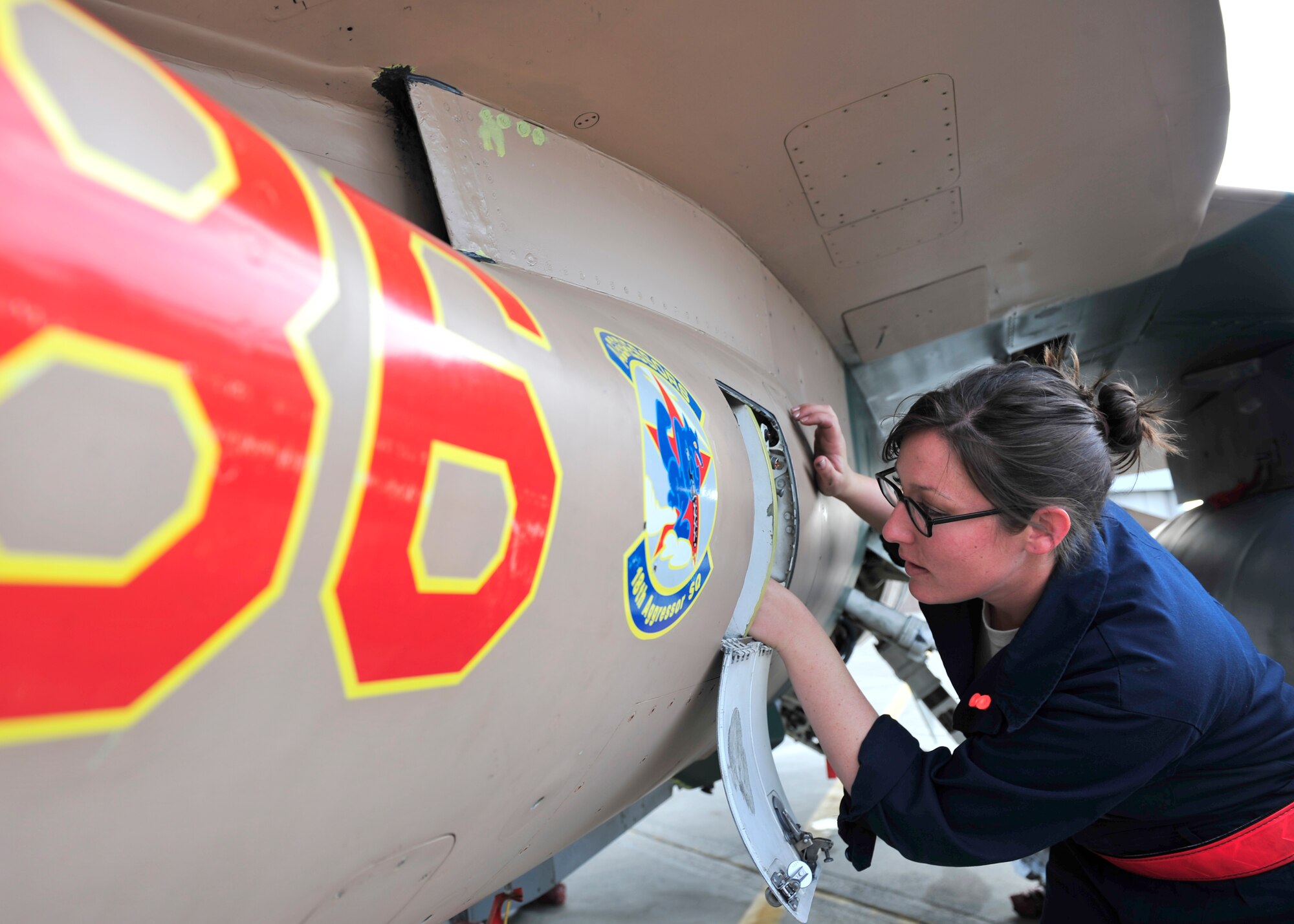 U.S. Air Force Airman 1st Class Sydney Stryker, 354th Aircraft Maintenance Squadron crew chief, inspects an engine bit ball on an F-16 Fighting Falcon May 16, 2014, Eielson Air Force Base, Alaska. Stryker checks the aircraft to ensure it is safe for flight. (U.S. Air Force photo by Senior Airman Ashley Nicole Taylor/Released)