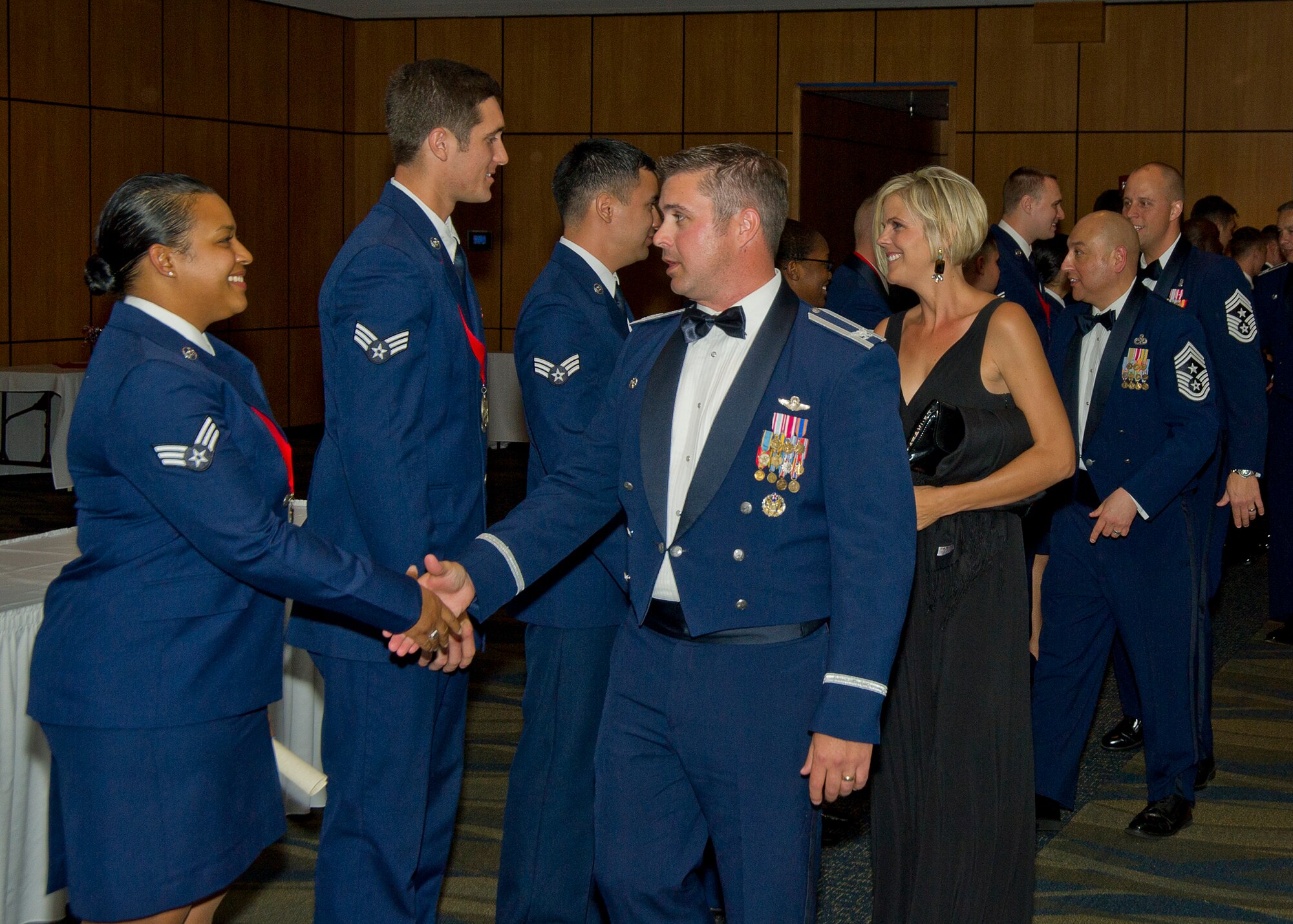 Col. David E. Graff, 325th Fighter Wing Commander, and wife, Jamee Graff, congratulate the Airman Leadership School Class 14-4 graduates during a ceremony May 15 at the Horizons Community Center. Airman Leadership School is a five week-long Air Force program designed to develop Airmen into effective front-line supervisors. (U.S. Air Force photo by Airman 1st Class Alex Echols)