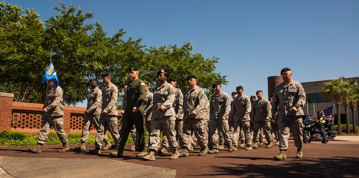 Members of the 628th Security Forces Squadron march towards the flagpole for a retreat ceremony May 16, 2014, on Joint Base Charleston, S.C. The 628th SFS was accompanied by members of the Patriot Guard Riders, a non-profit organization which ensures dignity and respect at memorial services honoring fallen military heroes, first responders and honorably discharged veterans. (U.S. Air Force photo/ Airman 1st Class Clayton Cupit)