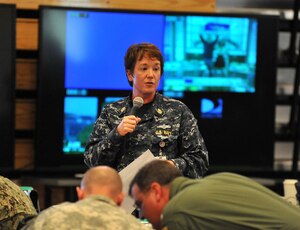 U.S. Navy Chief Petty Officer Kristine Ingle, Aerographer's Mate, Joint Intelligence Fusion Center, briefs weather conditions and the impact it has on response operations at a shift change during Sudden Response 2014 at Camp Dawson, W.Va, May 13, 2014. Shift change briefs are structured to cover the current situation and any changes to the plan or commanders intent. Sudden Response 2014 tests and validates the unit's movement of equipment and personnel during the initial phases of a simulated man-made or natural disaster. (DOD photo by U.S. Navy Petty Officer 1st Class Brian Dietrick/Released)