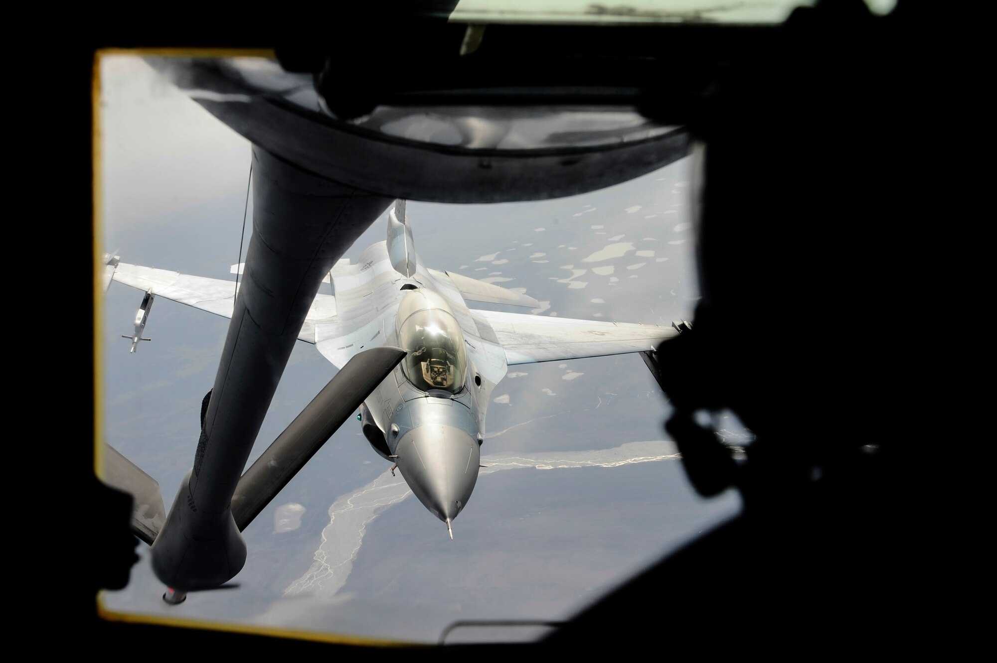 A U.S. Air Force F-16 Fighting Falcon pilot from the 18th Aggressor Squadron, Eielson Air Force Base, Alaska, approaches a KC-135 Stratotanker to be refueled over the Joint Pacific Alaska Range Complex during RED FLAG-Alaska 14-1 May 15, 2014. RF-A provides participants the unique opportunity to integrate various forces in a simulated combat environment. (U.S. Air Force photo by Senior Airman Zachary Perras/Released)