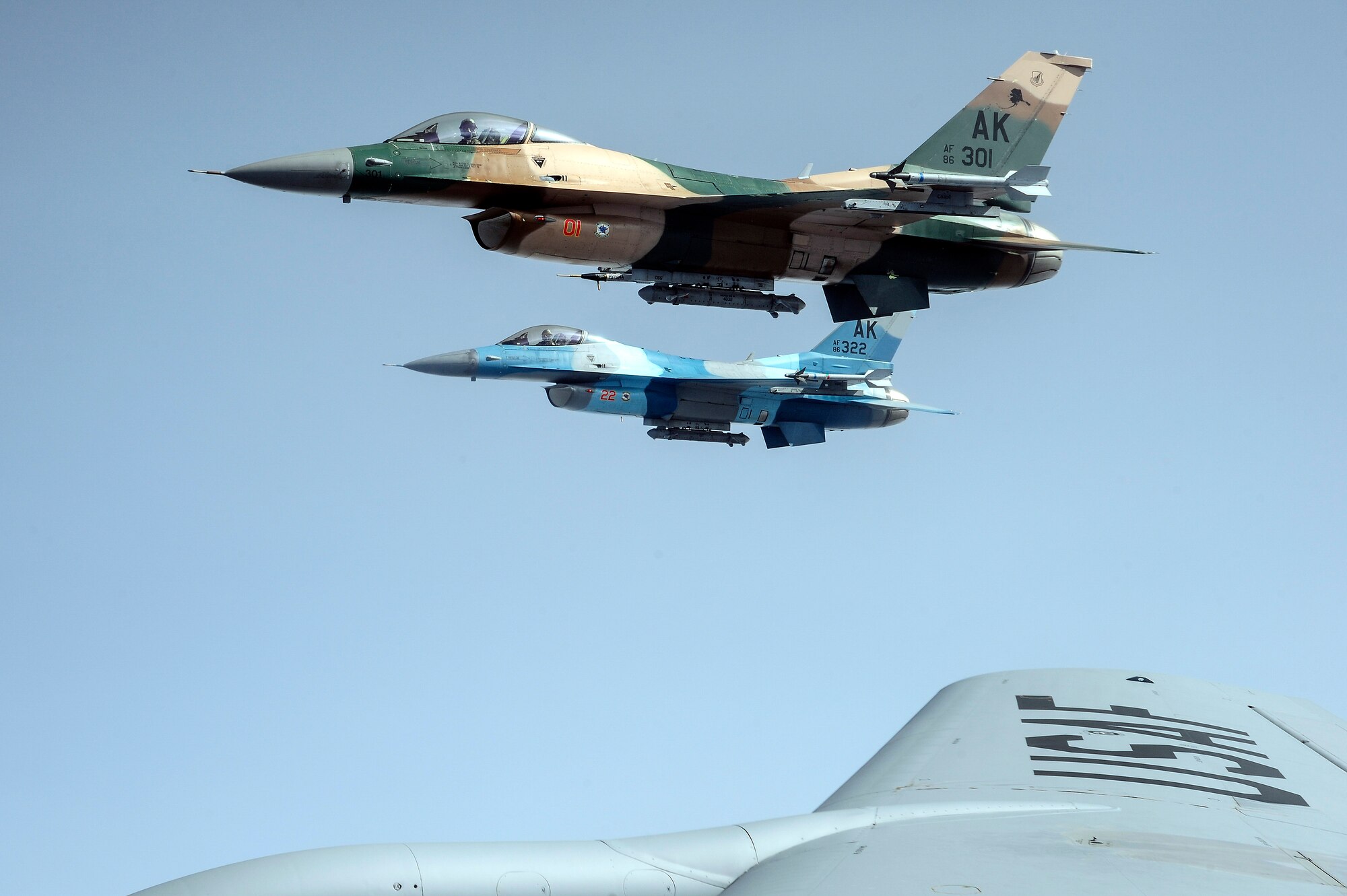 Two U.S. Air Force F-16 Fighting Falcons from the 18th Aggressor Squadron, Eielson Air Force Base, Alaska, fly alongside a KC-135 Stratotanker over the Joint Pacific Alaska Range Complex during RED FLAG-Alaska 14-1 May 15, 2014. The 18th AGRS trains allied and coalition forces with real-world combat scenarios by mimicking adversarial flying techniques. (U.S. Air Force photo by Senior Airman Zachary Perras/Released)