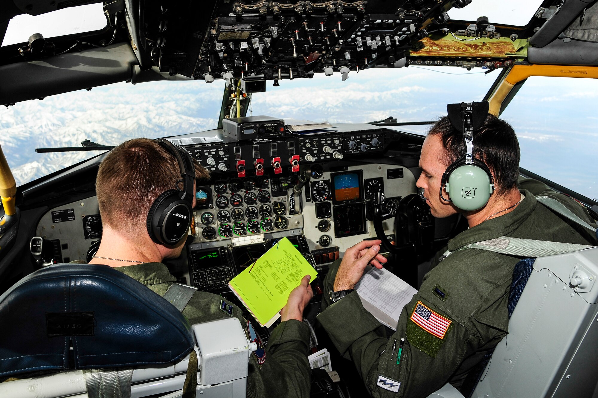 Capt. Skylar Rollins and 1st Lt. Myles McDowell, 911th Air Refueling Squadron pilots from Seymour-Johnson Air Force Base, N.C., discuss in-flight procedures over the Joint Pacific Alaska Range Complex during RED FLAG-Alaska 14-1 May 15, 2014. The two-week long exercise is the first of four scheduled for 2014. (U.S. Air Force photo by Senior Airman Zachary Perras/Released)