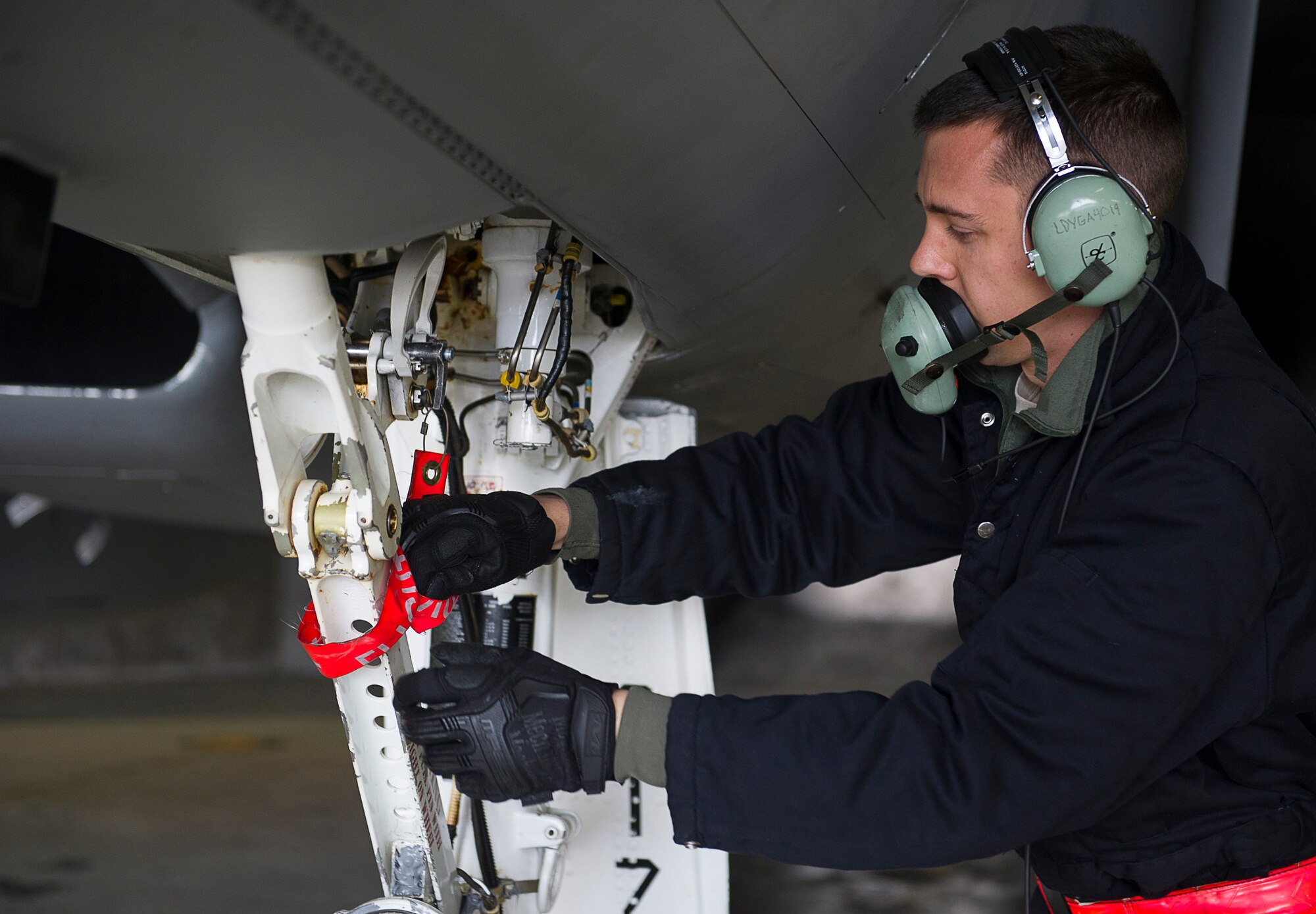 KEFLAVIK, Iceland – Senior Airman Andrew Kiel, 48th Air Expeditionary F-15C Eagle crew chief, secures a remove before flight streamer while preparing an aircraft for takeoff at Keflavik International Airport May 15, 2014. The crew chief is certifying to scramble for short-notice takeoffs so the group can perform the mission of protecting Iceland’s airspace while deployed for Icelandic Air Policing. (U.S. Air Force photo/Tech. Sgt. Benjamin Wilson)(Released)
