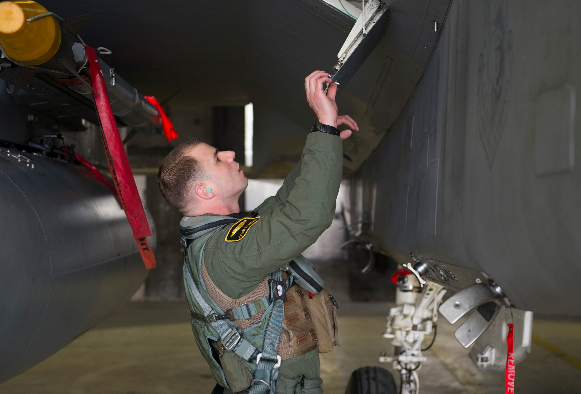 KEFLAVIK, Iceland – 1st Lt. Tyler Studeman, 48th Air Expeditionary F-15C Eagle pilot, performs preflight checks on his aircraft at Keflavik International Airport May 15, 2014. Studeman is certifying to scramble for short-notice takeoffs so the group can perform the mission of protecting Iceland’s airspace while deployed for Icelandic Air Policing. (U.S. Air Force photo/Tech. Sgt. Benjamin Wilson)(Released)