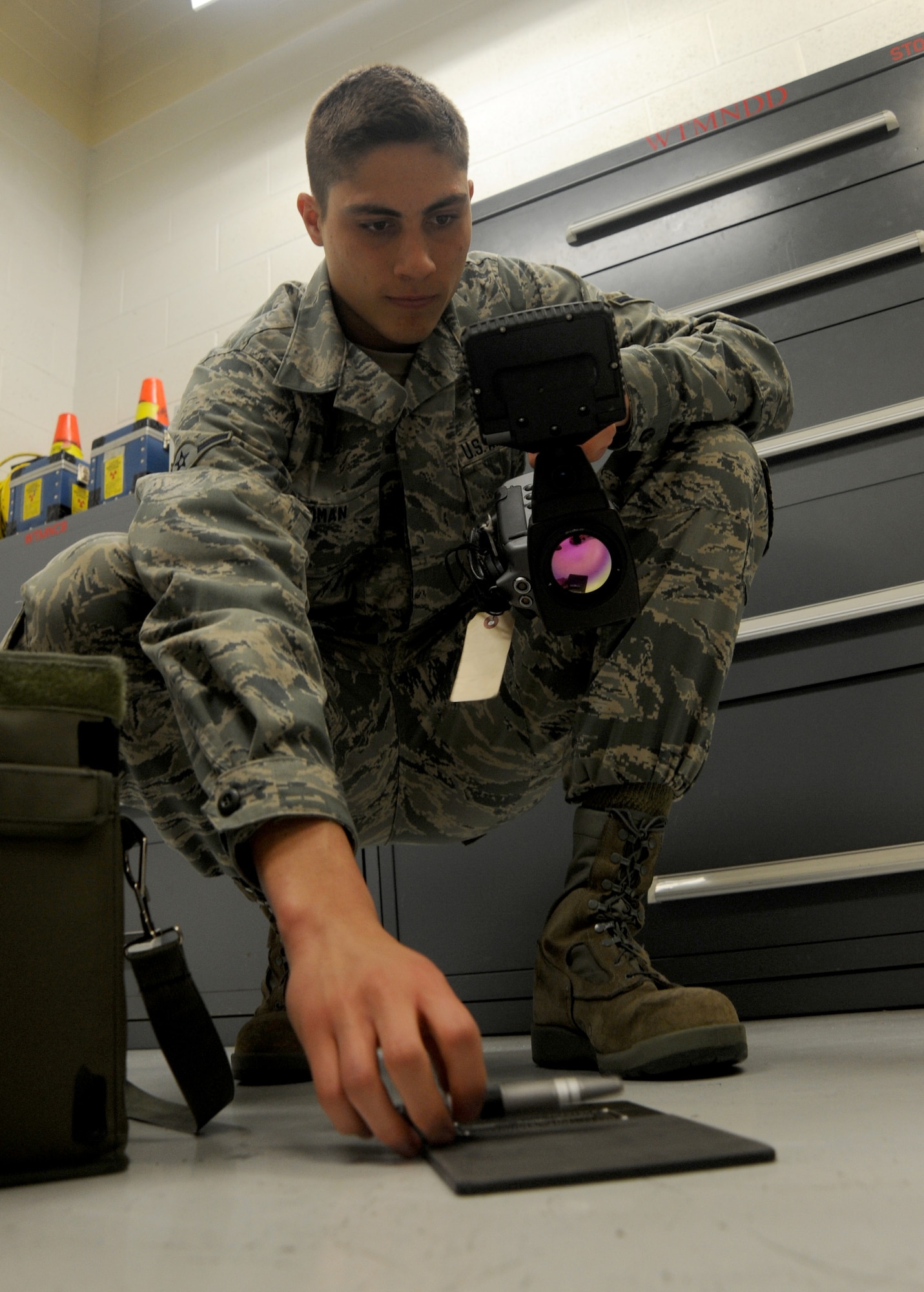 Airman Kawika Cadman, 509th Maintenance Squadron non-destructive inspection technician, prepares his infrared technology to search for discrepancies on individual aircraft parts at Whiteman Air Force Base, Mo., May 8, 2014. To become fully trained to work on aircraft, NDI shop members attend a 10-week technical training course and complete 12 months of on-the-job training. (U.S. Air Force photo by Senior Airman Bryan Crane/Released)