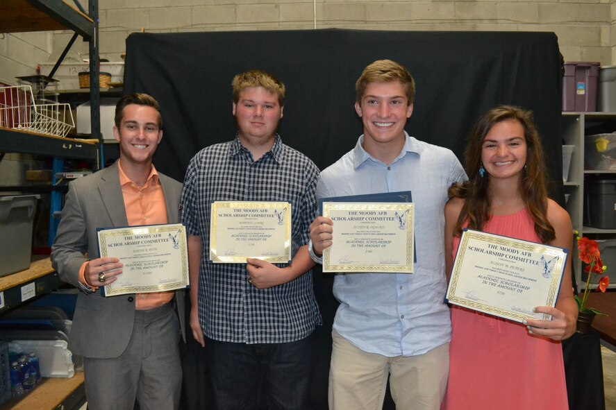 Team Moody family members pose with scholarship certificates from the Moody Thrift Shop, May 17, 2014, at Moody Air Force Base, Ga.  (From left) Joseph Ruse, Robert Cohrs, Austin Ogburn and Alison Peters, all graduating high school seniors, earned scholarships from the Thrift Shop based on their academics, volunteerism and a written essay judged by members of the Valdosta/Lowndes County Retired Teachers Association. The students received a cumulative total of $3,000, which was funded through sales and donations at the Thrift Shop. (Courtesy photo)