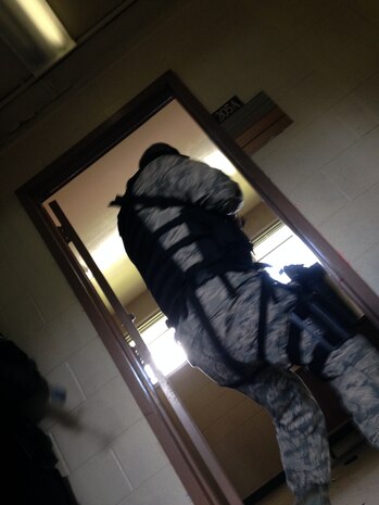 Col. Jeffrey Devore, Joint Base Charleston commander prepares to enter a room during a sweep of a building during an Active Shooter exercise May 14, 2014, at Joint Base Charleston – Weapons Station. DeVore was riding along with the 628th SFS as part of a program designed to give base leaders a taste of what Airmen and Sailors do at their job centers every day. (U.S. Air Force photo/Master Sgt. Jennifer Crerar)