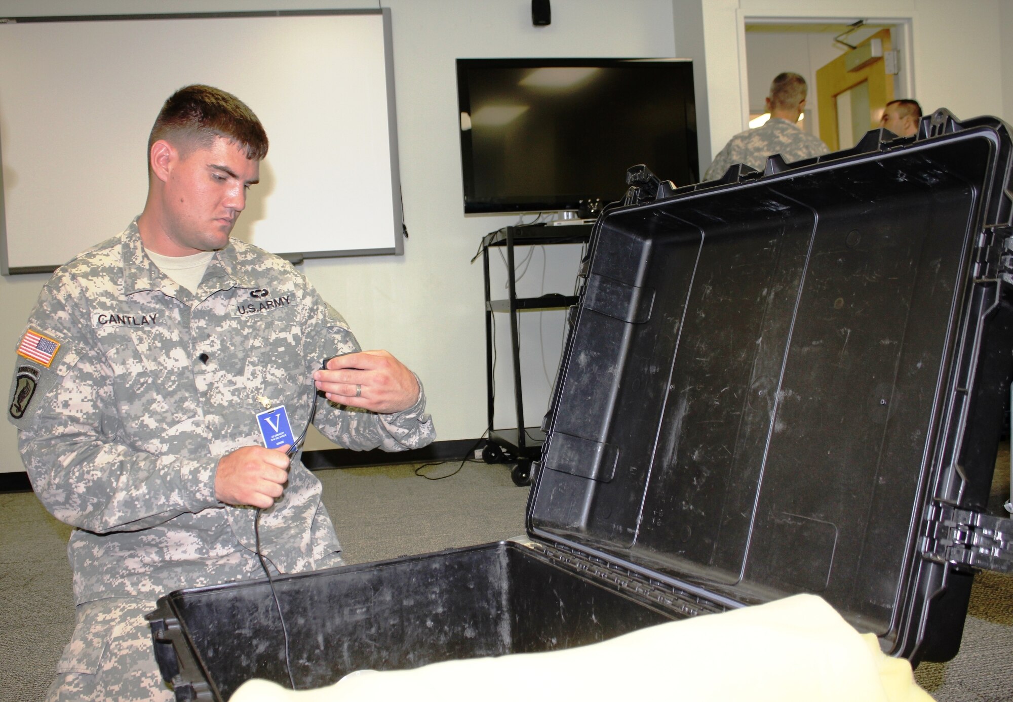 U. S. Army Spc. Cory Cantlay, a signal support systems specialist with the SOUTHCOM Situational Assessment Team, unpacks communications equipment during set up at the U.S. Embassy in El Salvador as part of the FA-HUM 2014 exercise. The SSAT was deployed for the first time for FA-HUM 2014, a humanitarian and disaster relief exercise in San Salvador, El Salvador.