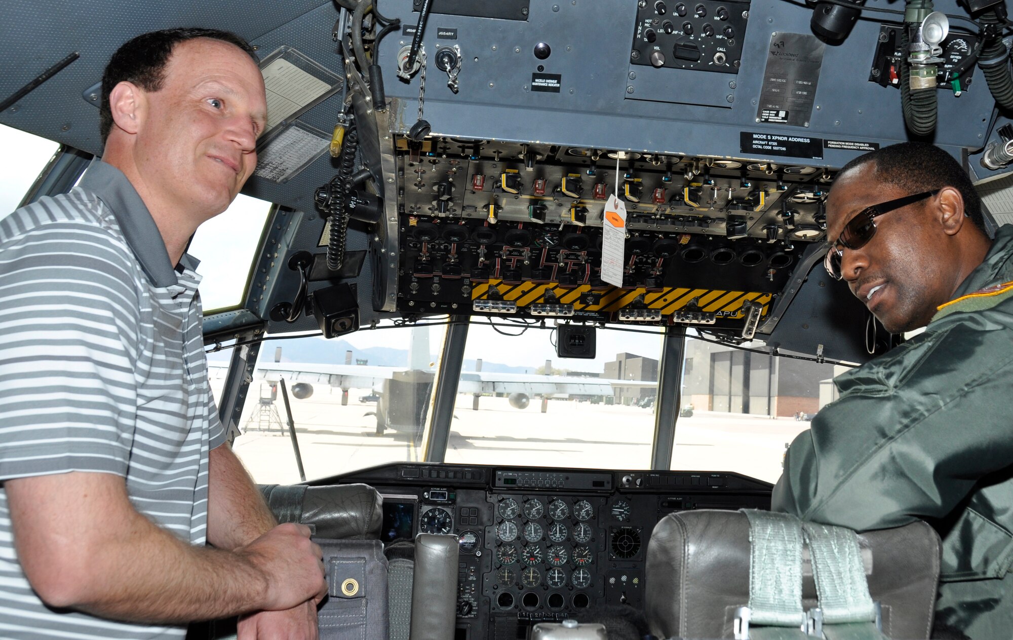 PETERSON AIR FORCE BASE, Colo. - Troy Calhoun, U.S. Air Force Academy football head coach tours the flight deck of a C-130H with Master Sgt. Frank Murraine, 52nd Airlift Squadron flight engineer, during his visit May 9, 2014 here. Calhoun was invited by the 302nd Airlift Wing’s active duty associate unit, the 52nd AS, to speak to Airmen about leadership. The coach said his idea of leadership is someone who has integrity, passion, a plan and perseverance. He went on to comment on the Airmen he met that afternoon. “I can tell you all twelve games we are going to play [next season.] I can tell you the date, the time we are going to kick off. Many of the missions you have to carry out, you don’t know what that’s going to be. And that’s what makes you special. It’s remarkable the professionalism that you exhibit. I want to thank each and everyone of you for your dedication and the commitment you made to serve,” said Calhoun. (U.S. Air Force photo/Master Sgt. Daniel Butterfield)