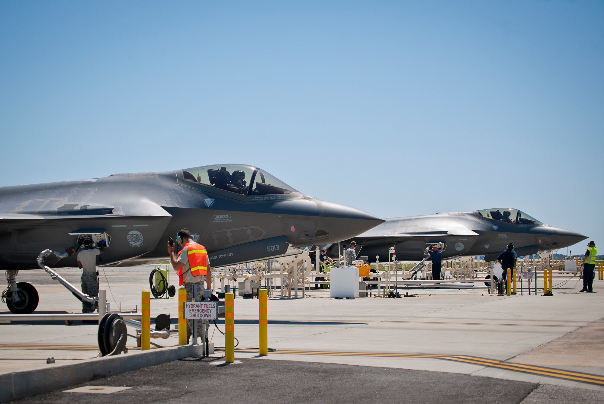 Lockheed Martin and 33rd Fighter Wing maintainers work with 96th Fuels Flight Airmen during a dual hot pit session May 6 at Eglin Air Force Base, Fla.  The fuels flight facilitates the four hot pit stations on the 33rd FW flightline used by Air Force, Marine Corps, Navy and international-partner F-35 aircraft. (U.S. Air Force photo/Samuel King Jr.)  