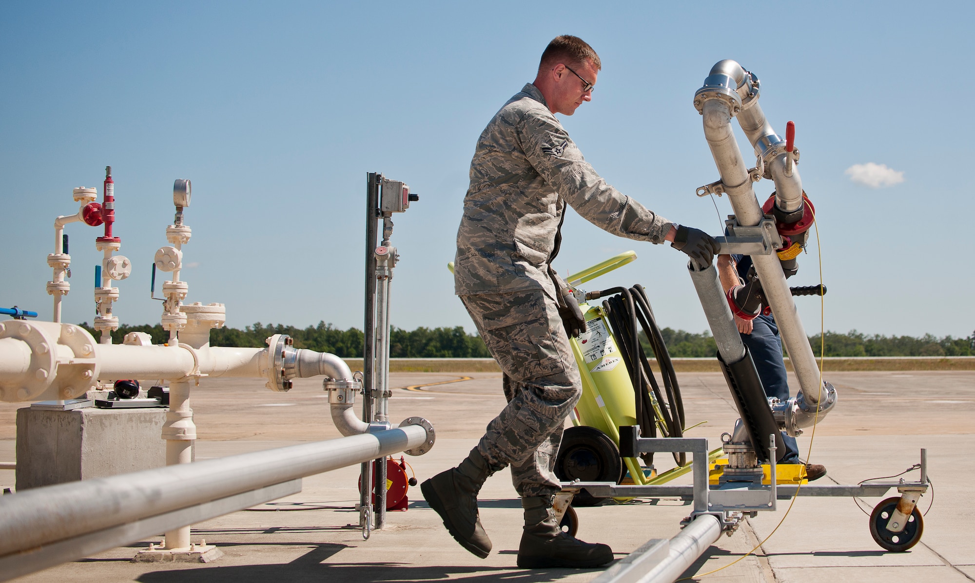 Airman 1st Class Matthew Roth, the 96th Fuels Flight, moves the fuel station’s arm into place prior to a 33rd Fighter Wing hot pitting session May 6 at Eglin Air Force Base, Fla.  The fuels flight facilitates the four hot pit stations on the 33rd FW flightline used by Air Force, Marine Corps and Navy F-35 aircraft. The 131 Airmen and civilians of the fuels flight fall under the 96th Logistics Readiness Squadron and were recently named best fuels flight in Air Force Materiel Command.  (U.S. Air Force photo/Samuel King Jr.)