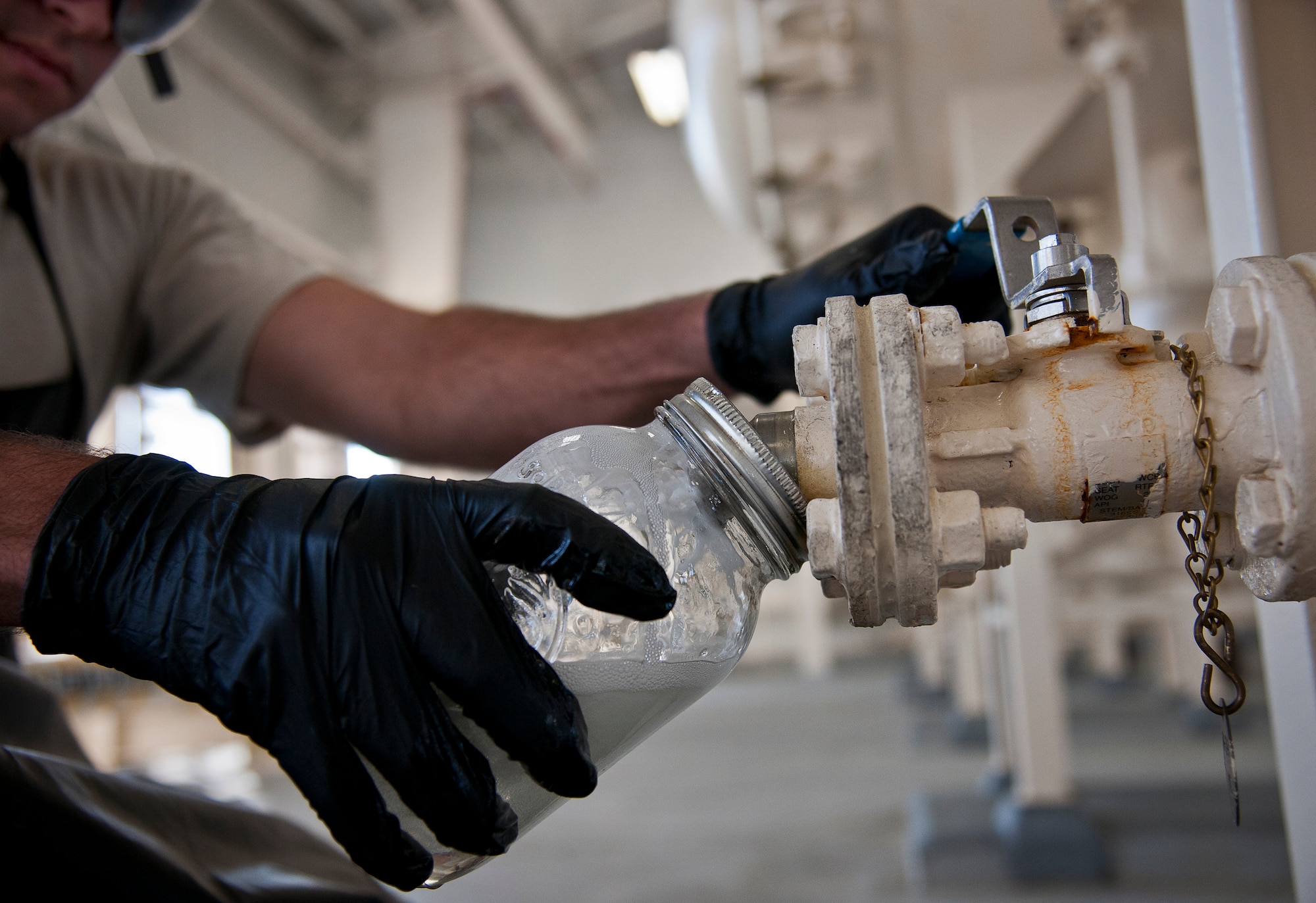 Staff Sgt. Tyler McInturff, the 96th Fuels Flight, takes a sample of Jet-A fuel from a filter separator May 6 at Eglin Air Force Base, Fla.  Fuel samples are taken to check if water and sediment amounts are detected.  (U.S. Air Force photo/Samuel King Jr.)