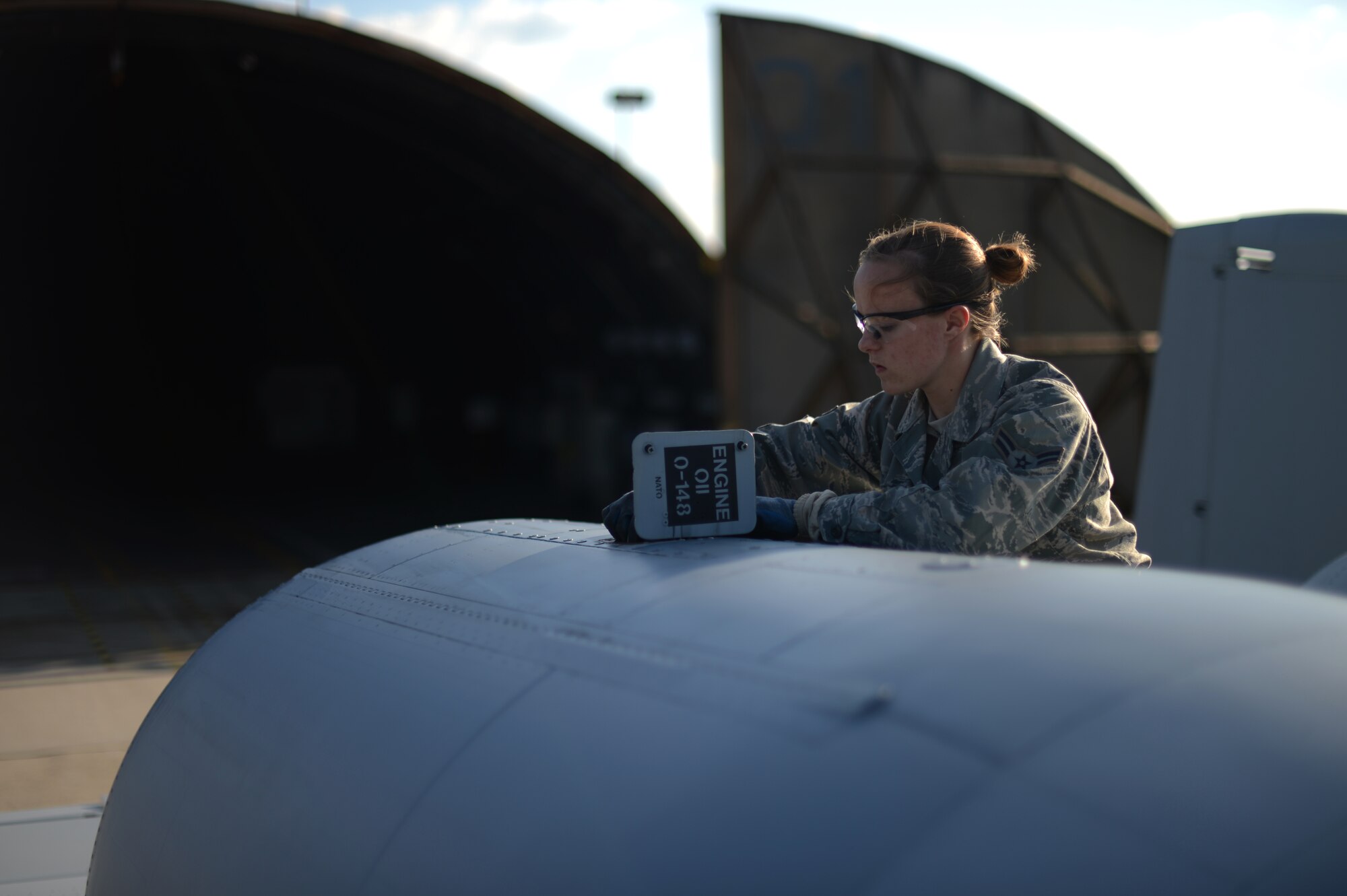 U.S. Air Force Airman 1st Class Natalya Brechlin, 124th Aircraft Maintenance Squadron crew chief from Boise, Idaho, checks the oil of a U.S. Air Force A-10 Thunderbolt II attack aircraft on the flightline at Spangdahlem Air Base, Germany, May 16, 2014. Airmen check oil after every flight to maintain the proper level and cleanliness of fluids inside the engine. (U.S. Air Force photo by Senior Airman Gustavo Castillo/Released) 