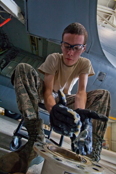 Airman 1st Class Gerald R. Meagher, 108th Wing Maintenance Squadron, New Jersey Air National Guard, greases a KC-135R Stratotanker wing landing gear axle brake collar May 18, 2014, at Joint Base McGuire-Dix-Lakehurst, N.J. (U.S. Air National Guard photo by Master Sgt. Mark C. Olsen/Released)