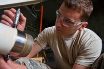 Senior Airman Andrew V. Balint, 108th Wing Maintenance Squadron, New Jersey Air National Guard, measures the diameter of a KC-135R Stratotanker wing landing gear axle during an inspection May 18, 2014, at Joint Base McGuire-Dix-Lakehurst, N.J. (U.S. Air National Guard photo by Master Sgt. Mark C. Olsen/Released)