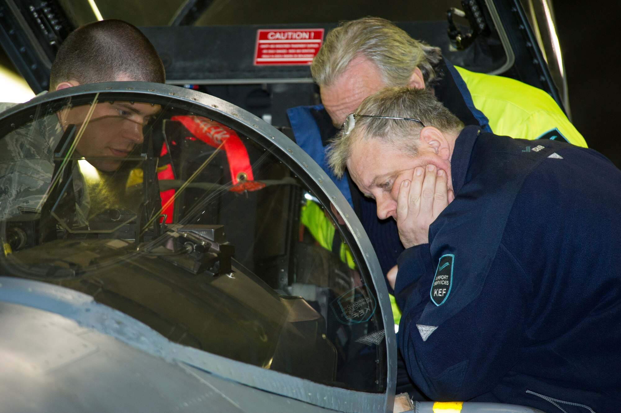 KEFLAVIK, Iceland -- Staff Sgt. Joshua Wilson (left), 48th Air Expeditionary Group egress technician, explains the ejection seat of an F-15C Eagle to emergency responders at Keflavik International Airport, May 16, 2014. The aircraft is deployed to Keflavik for the NATO mission of Icelandic Air Policing. In the event of an emergency, airfield services from the airport may need to assist the Airmen assigned to the mission. (U.S. Air Force photo/Tech. Sgt. Benjamin Wilson) (Released)
