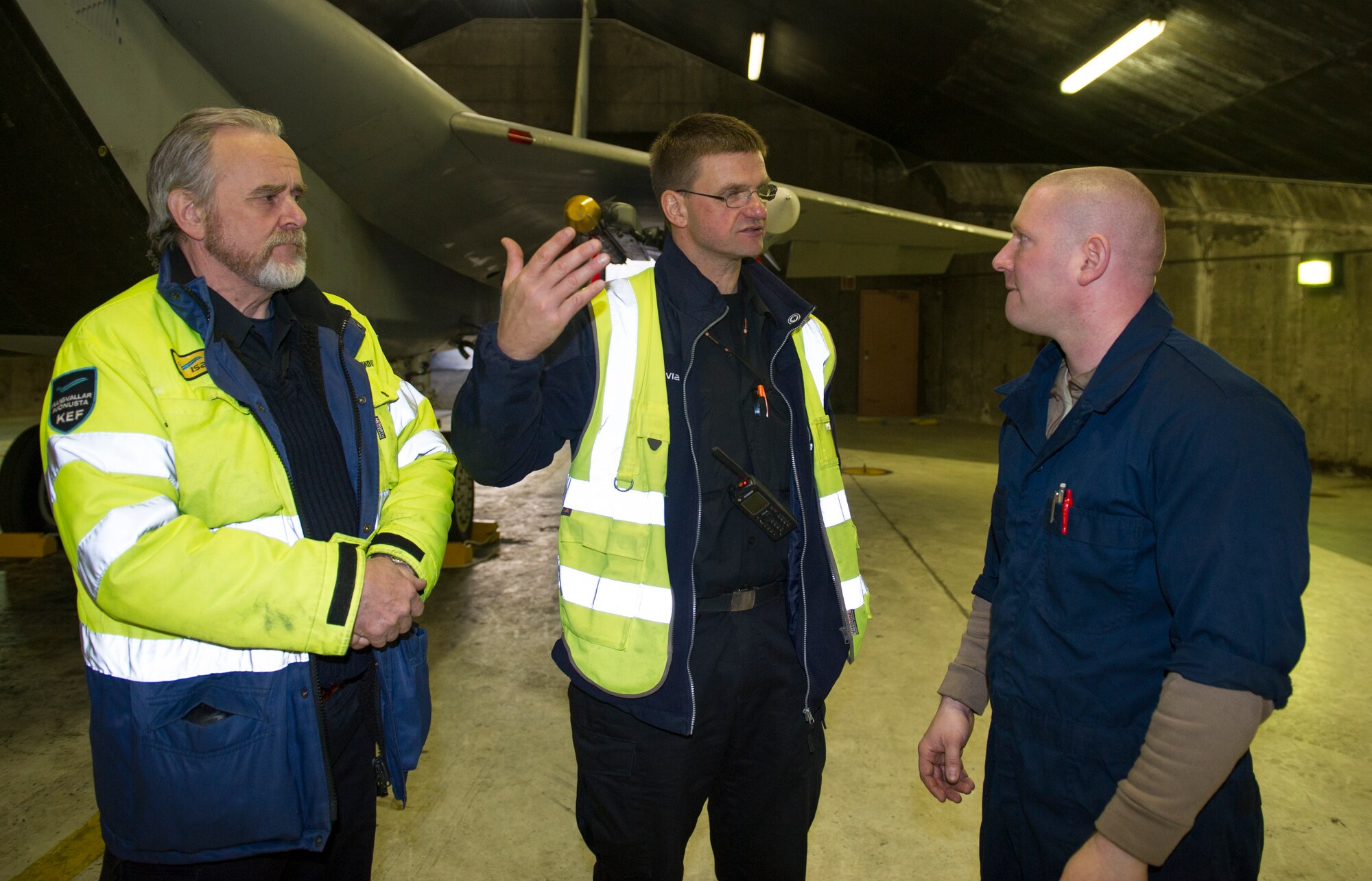 KEFLAVIK, Iceland -- Staff Sgt. Caleb Schauer (right), 48th Expeditionary Air Group dedicated crew chief, speaks with airfield service members during emergency response training at Keflavik International Airport, May 16, 2014. Airfield services were trained on pilot extraction procedures for the F-15C Eagle so they could help respond in the event of an emergency while the aircraft is deployed for Icelandic Air Policing. (U.S. Air Force photo/Tech. Sgt. Benjamin Wilson)(Released)