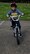 A military child pedals his bicycle during a bike safety rodeo at RAF Alconbury, United Kingdom, May 14, 2014. During the rodeo, children were given the opportunity to have their bike helmets sized and adjusted by Airmen from the 432rd Security Forces Squadron. (U.S. Air Force photo by Staff Sgt. Jarad A. Denton/Released)